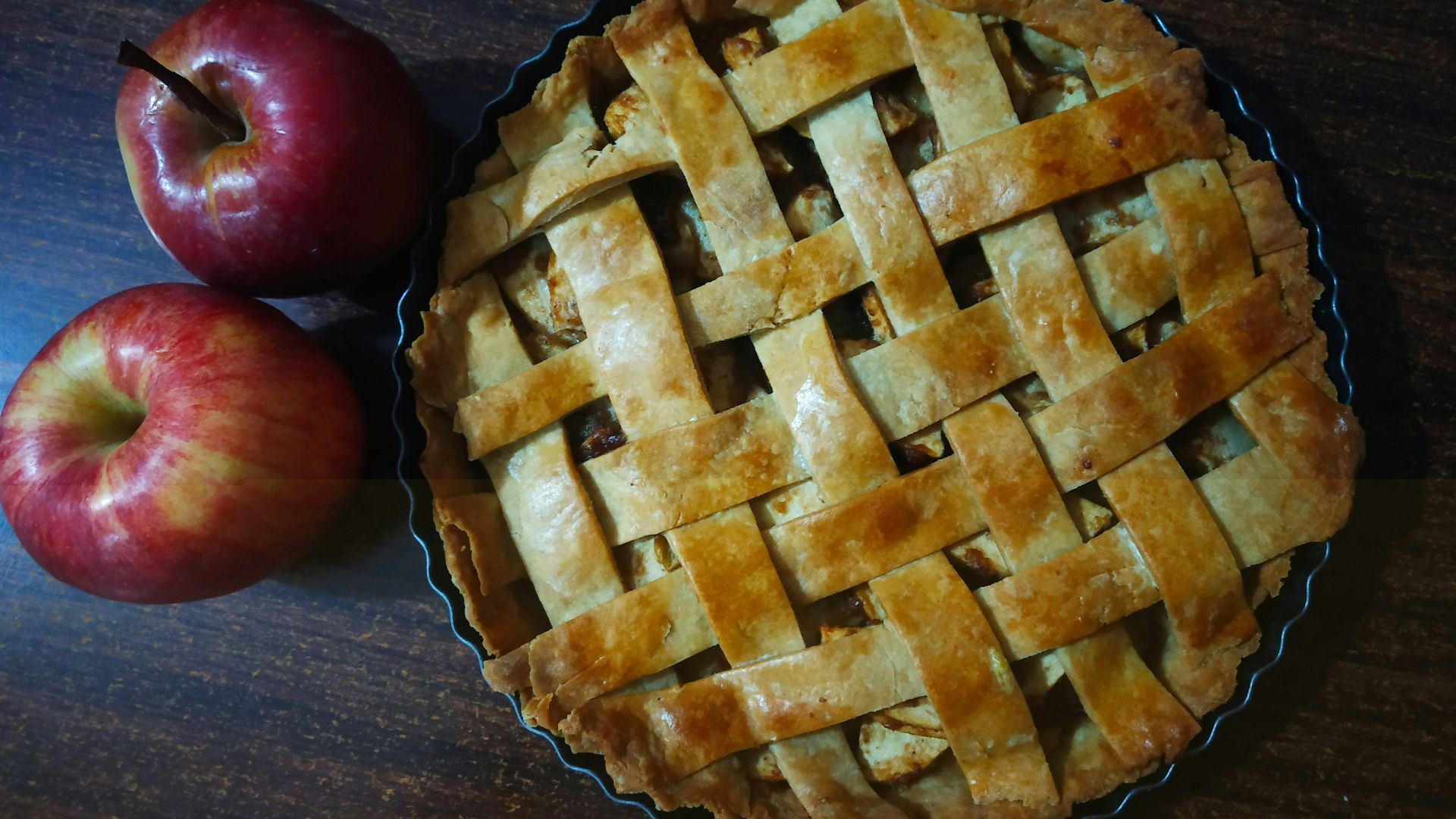red apple beside brown pie