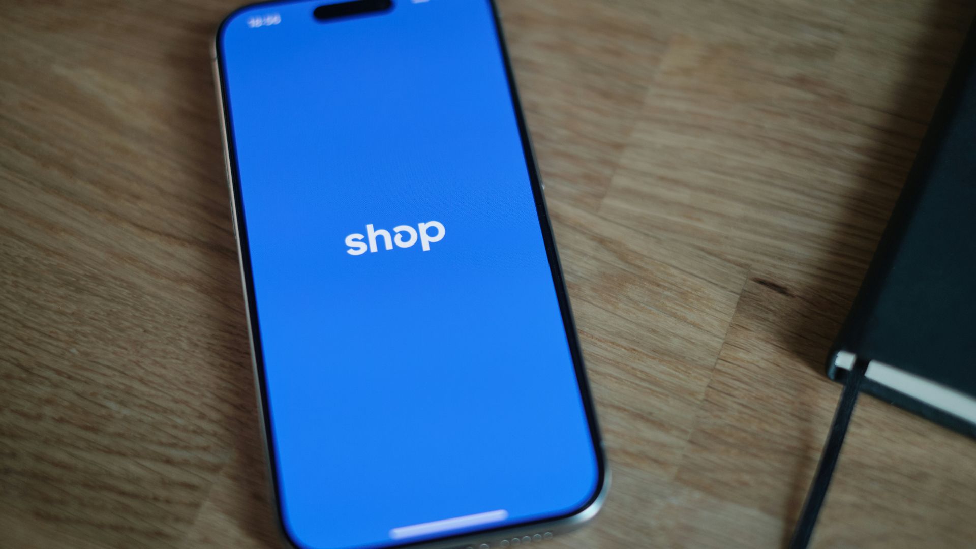 A cell phone sitting on top of a wooden table