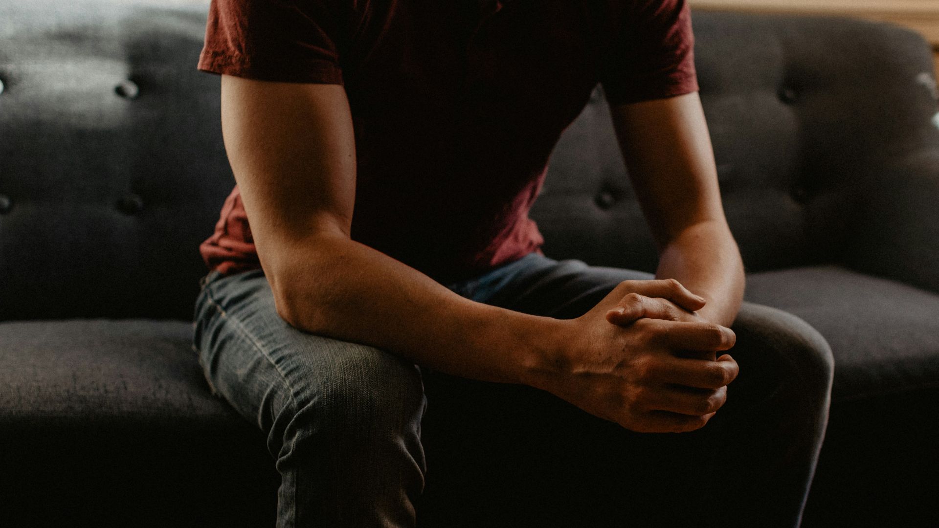 man sitting on sofa