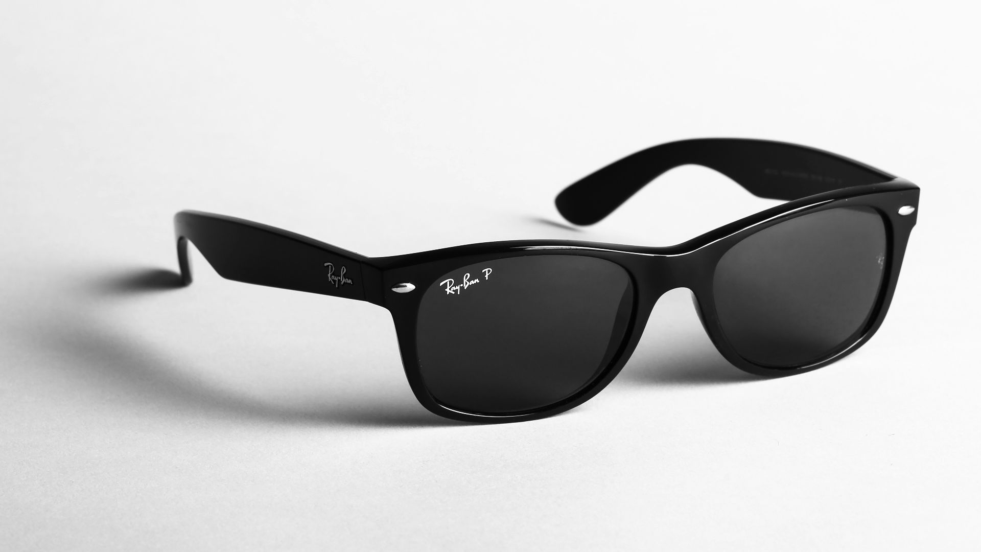 shallow focus photo of black Ray-Ban wayfarer sunglasses