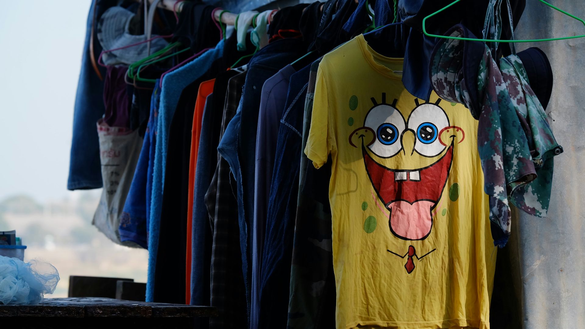 assorted shirt hanging on hanger near wall