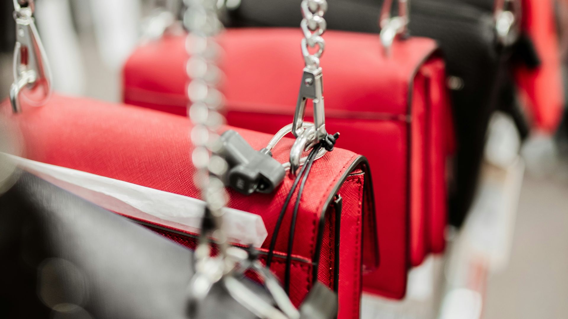 red and silver padlock on gray metal chain