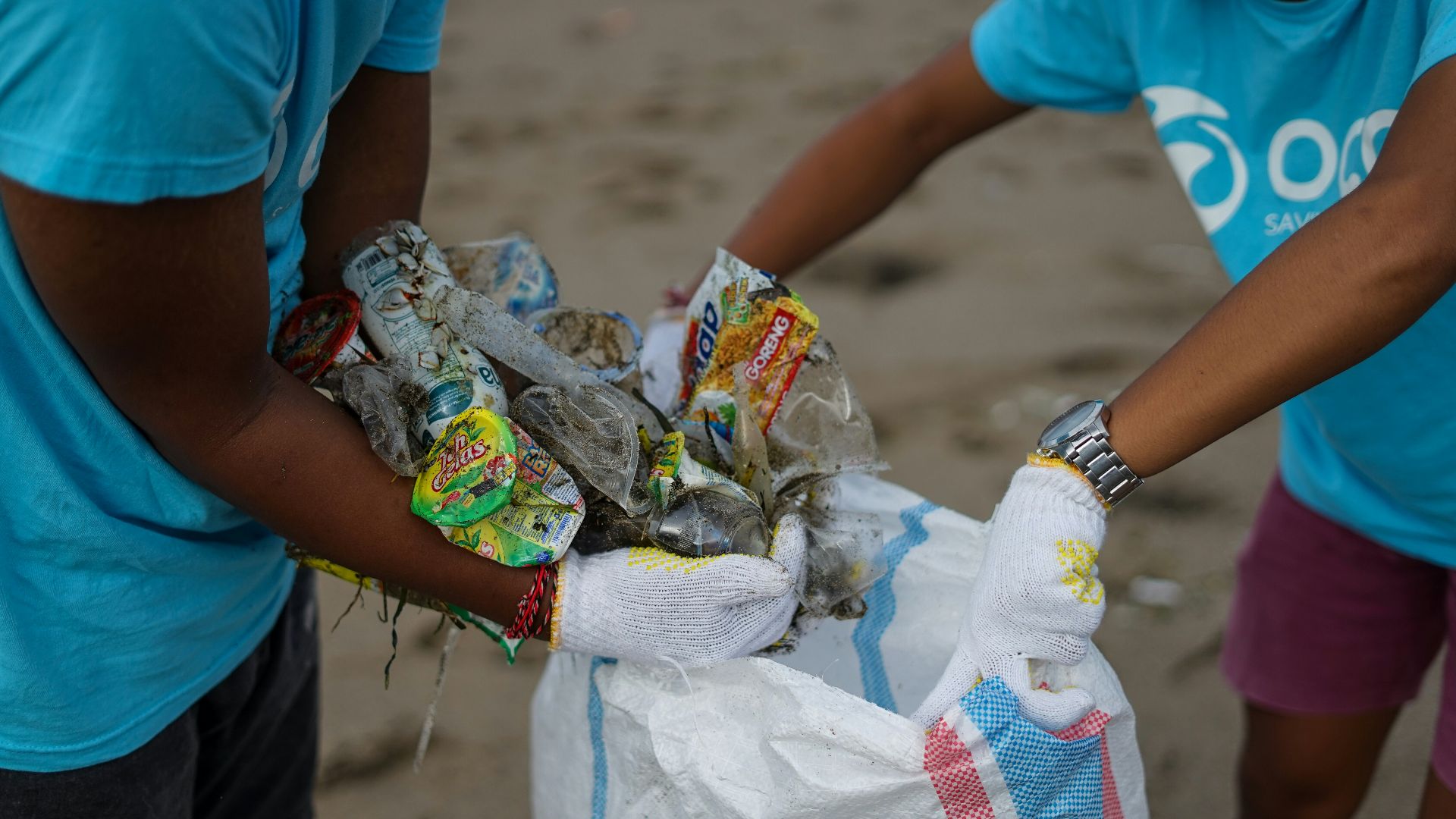 person in blue t-shirt holding white textile