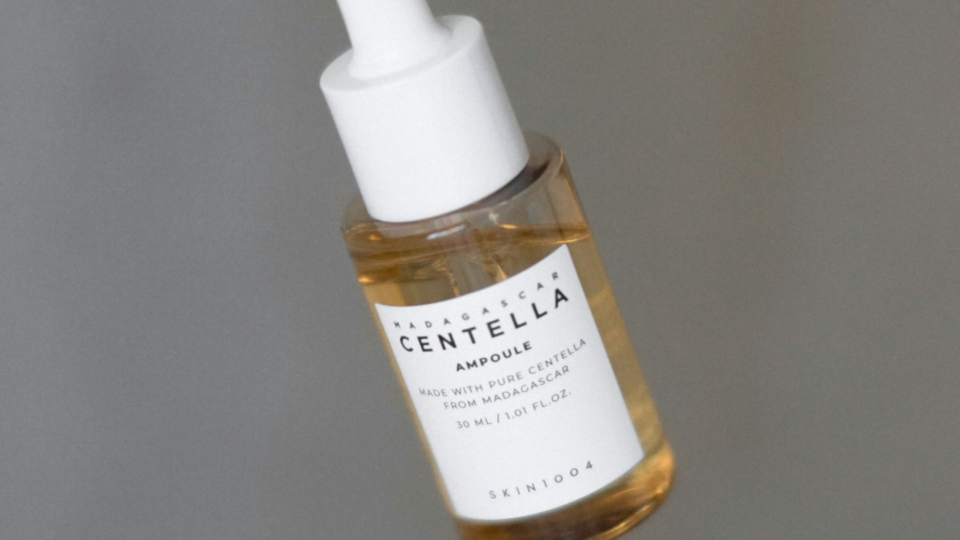 a dropper bottle filled with a drop of liquid