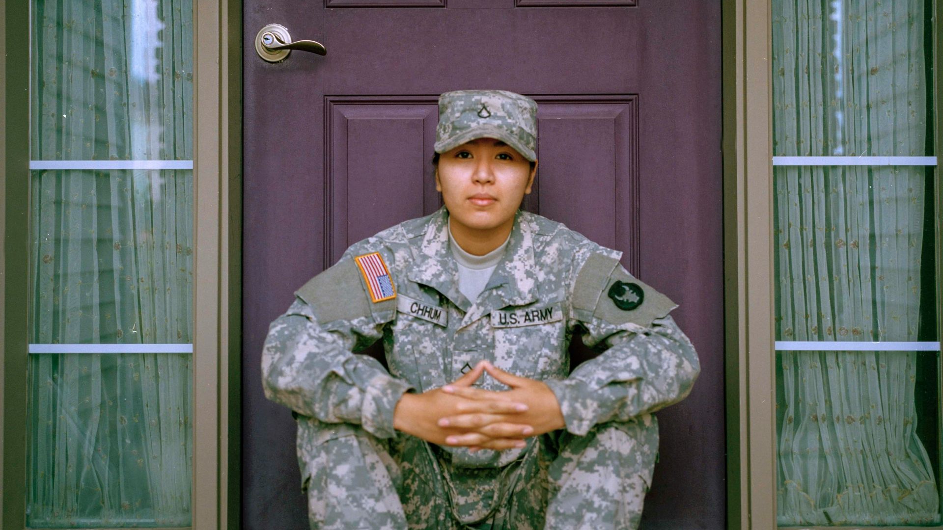 woman sitting in front of closed door