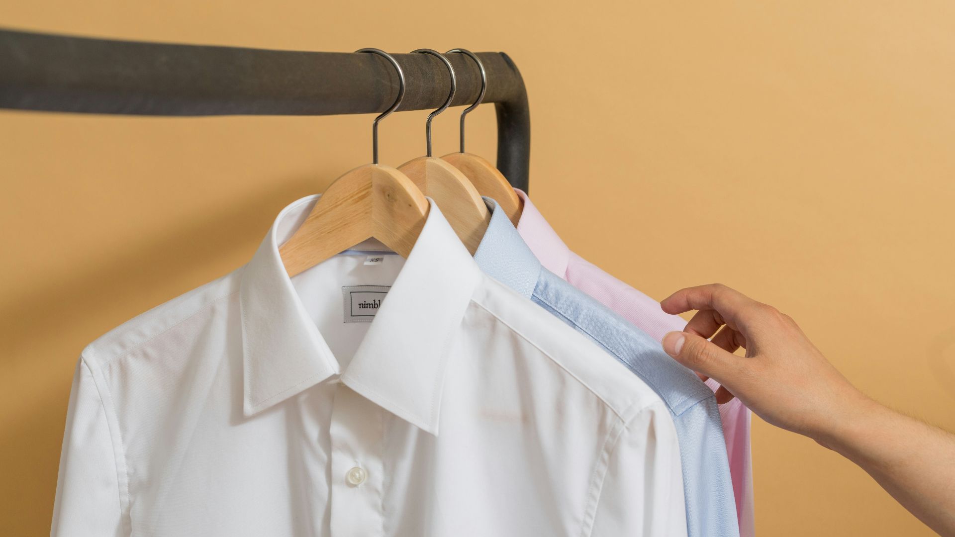 white button up shirt on black clothes hanger