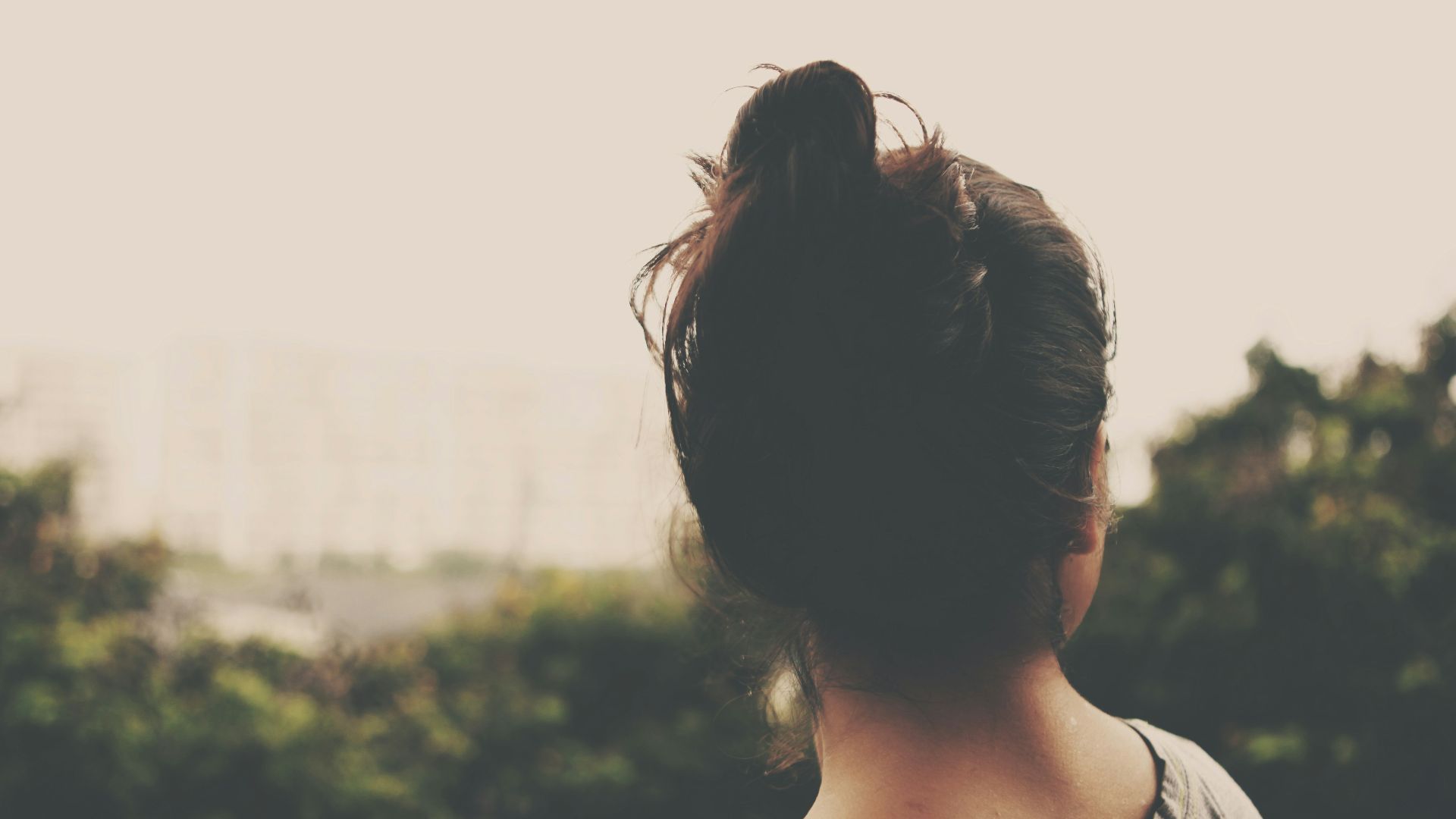 focus photography of woman facing trees