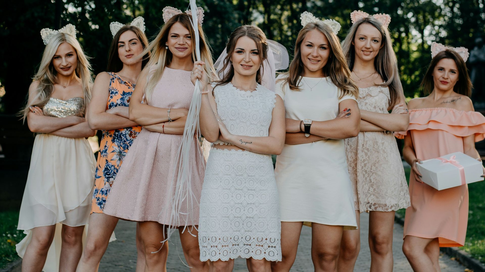 women standing side-by-side on street during daytime