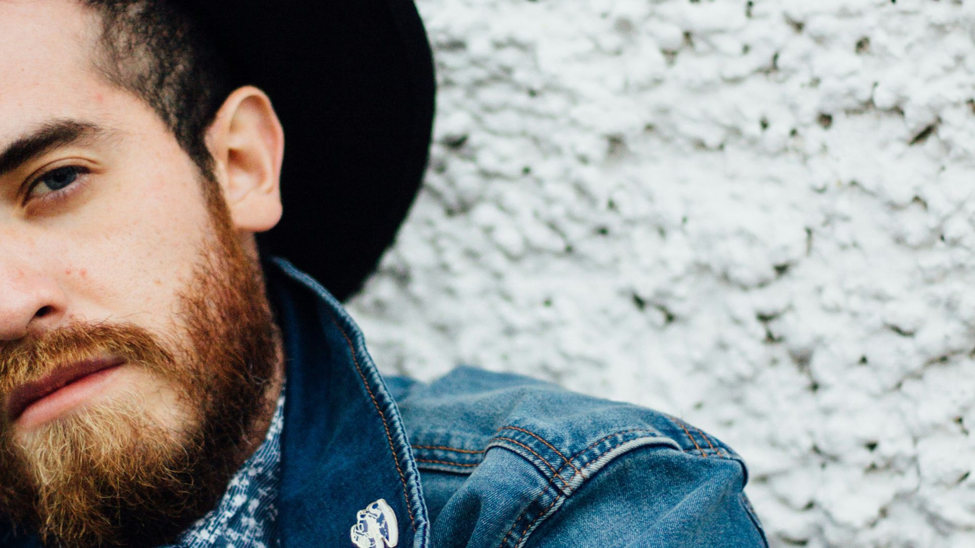 man wearing blue denim jacket