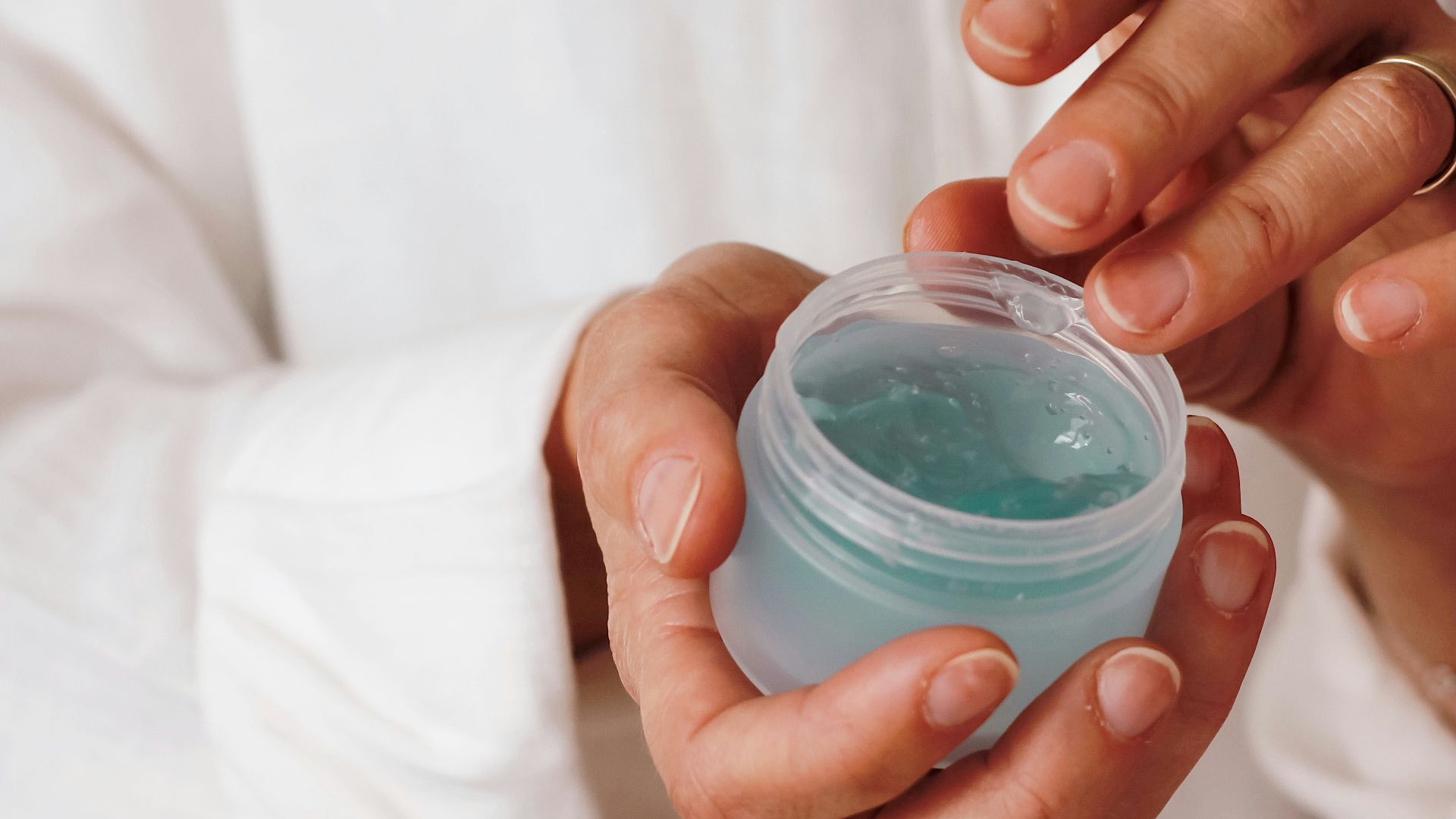 person holding blue plastic container