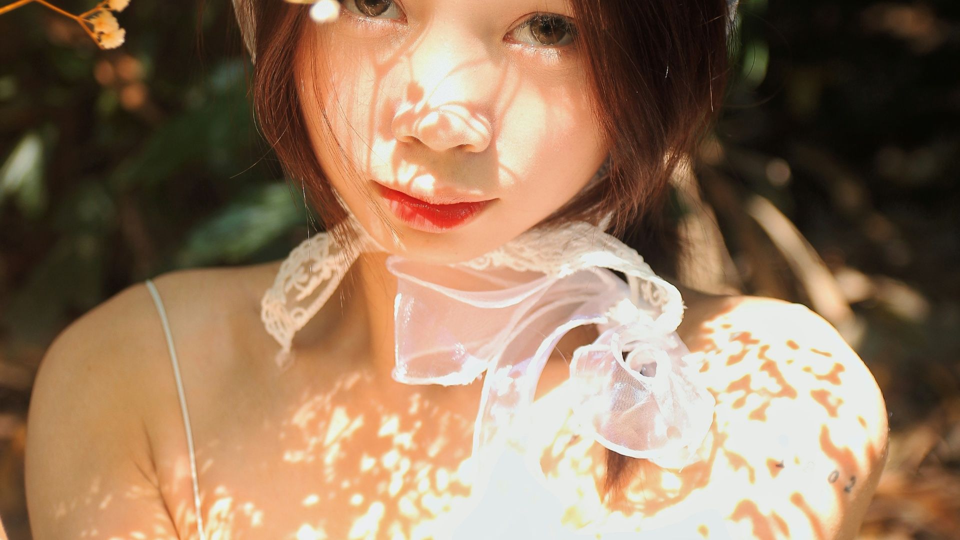 a woman in a white dress holding a bunch of flowers