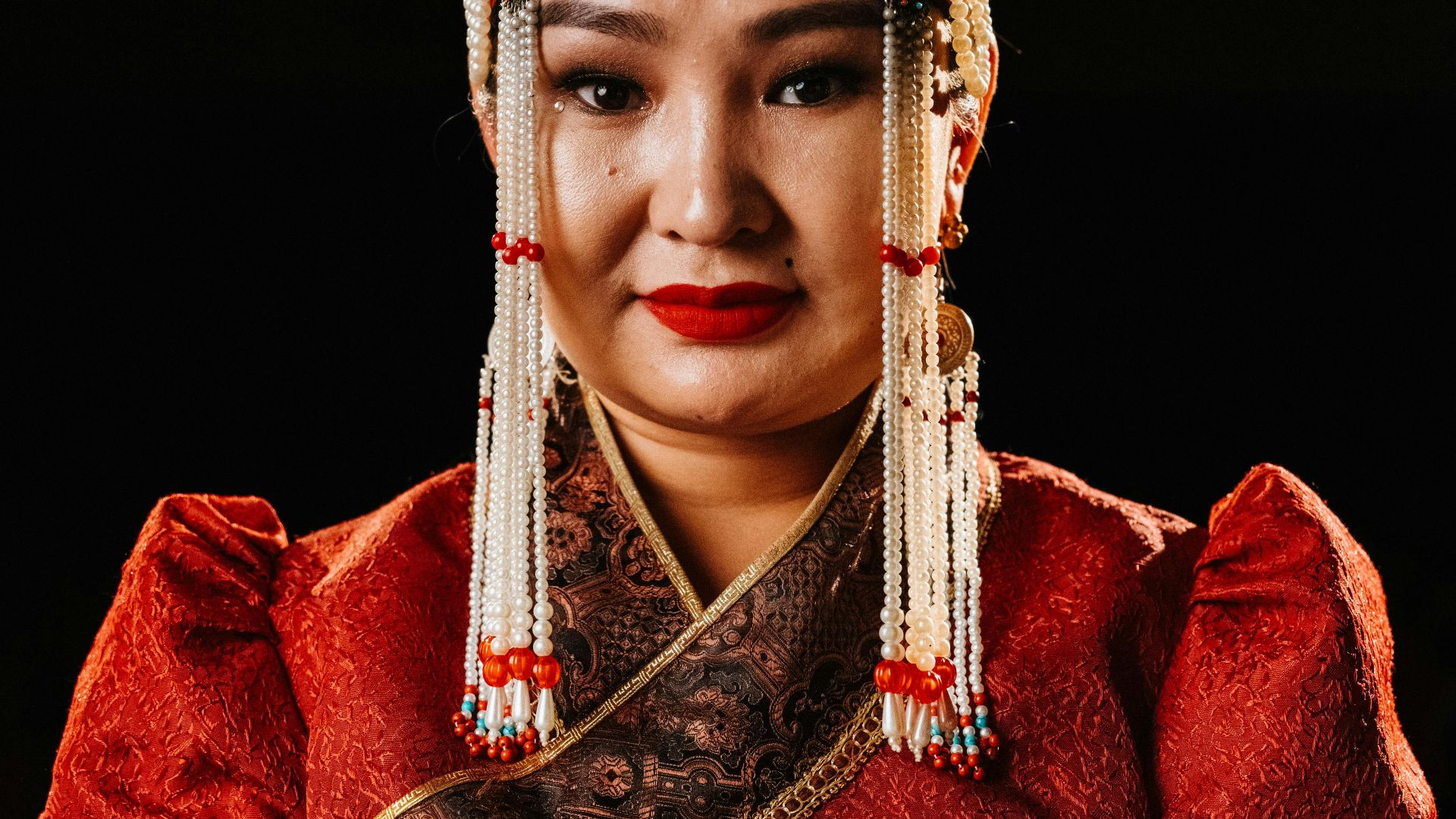 a woman in a red dress and headdress