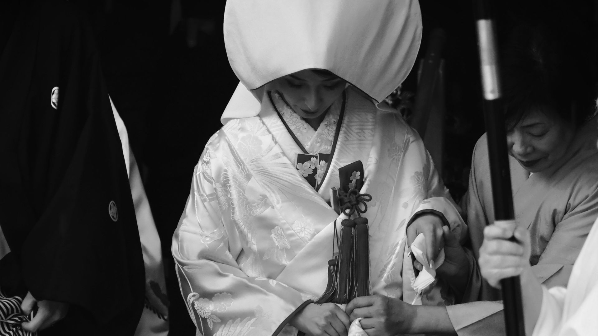 man in white robe holding stick