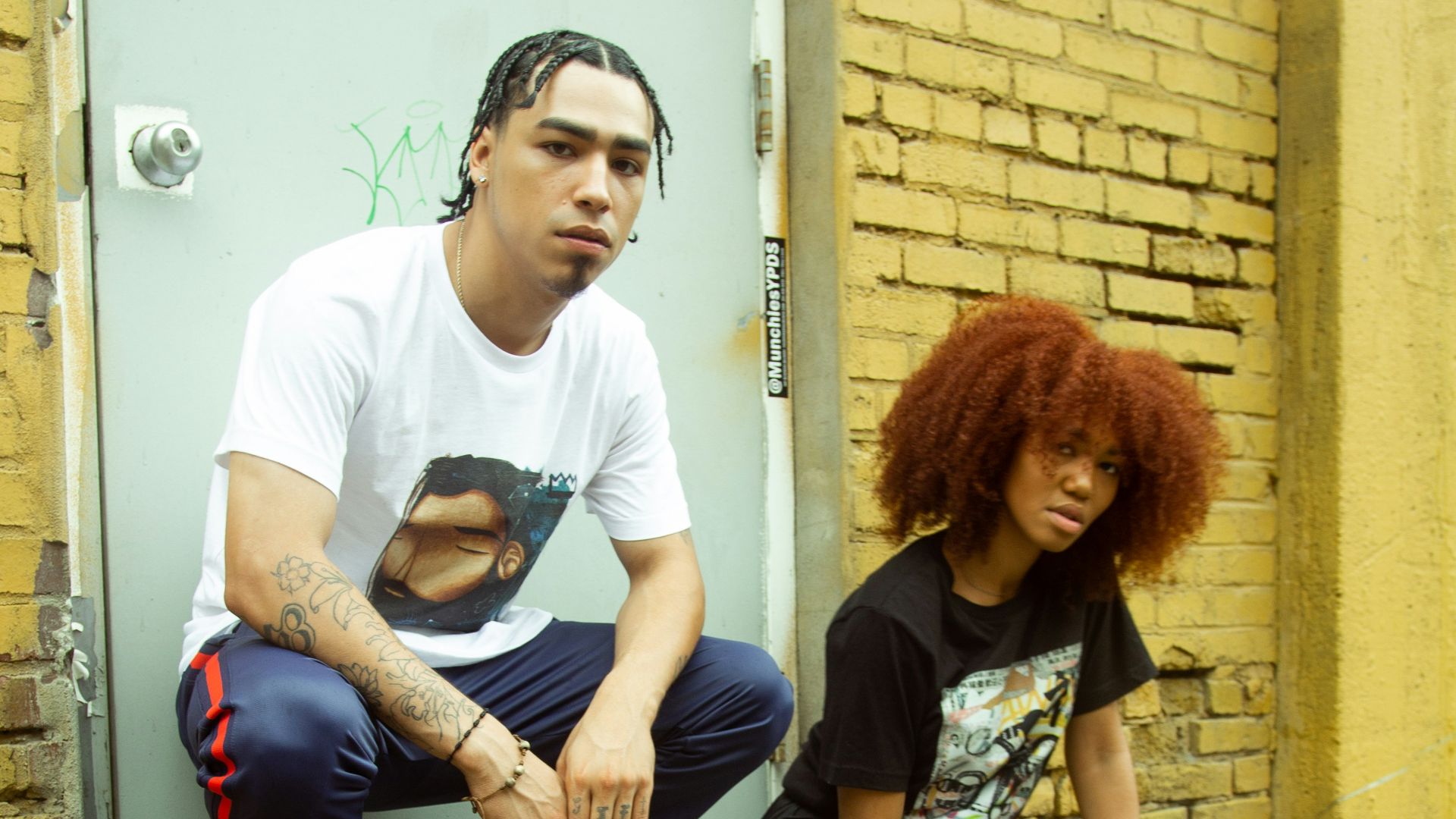 man and woman sitting on brown wooden bench
