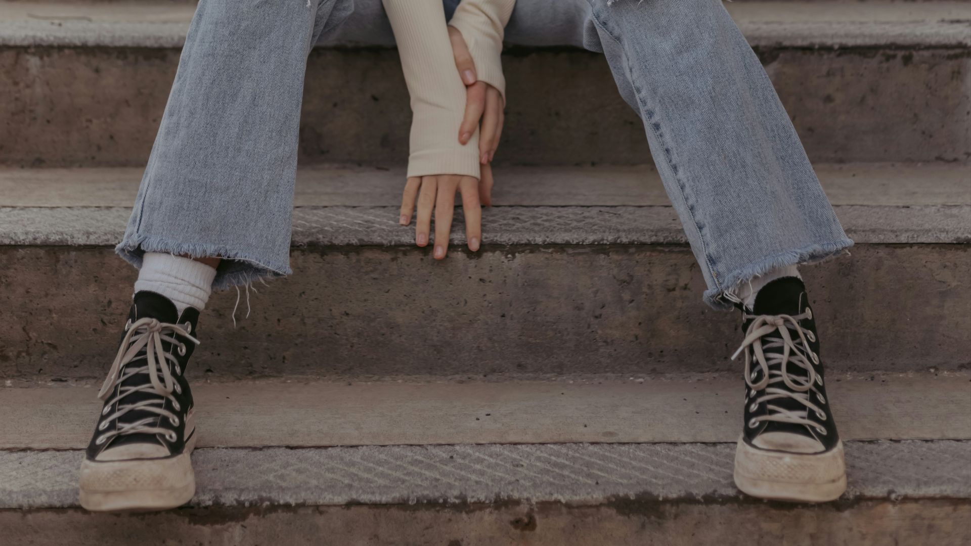 a woman sitting on the steps of a building