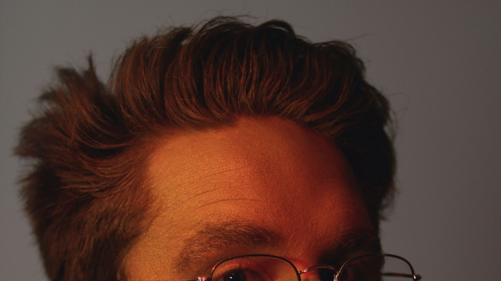shallow focus photo of man in black turtleneck shirt wearing eyeglasses