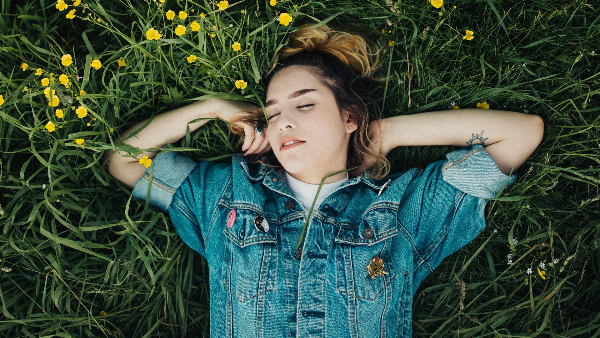 woman lying on grassland