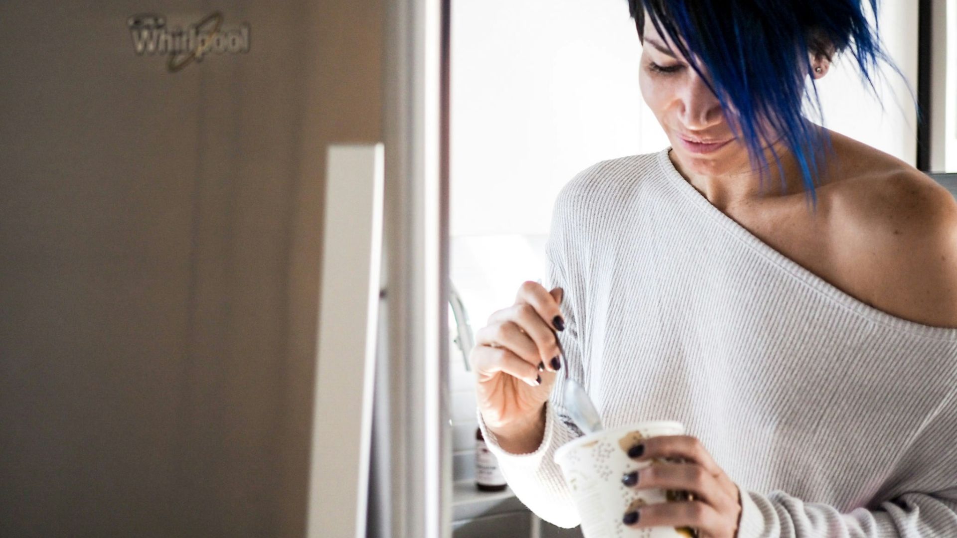 woman wearing white off-shoulder holding white cup