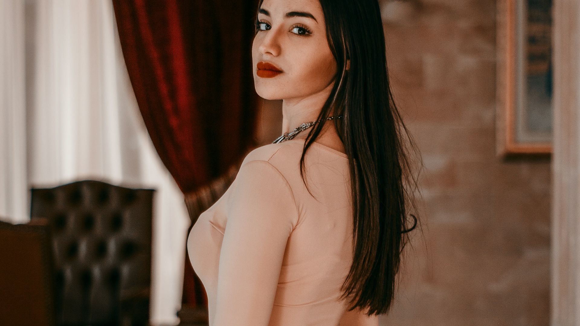 woman in white brassiere and panty standing near red curtain