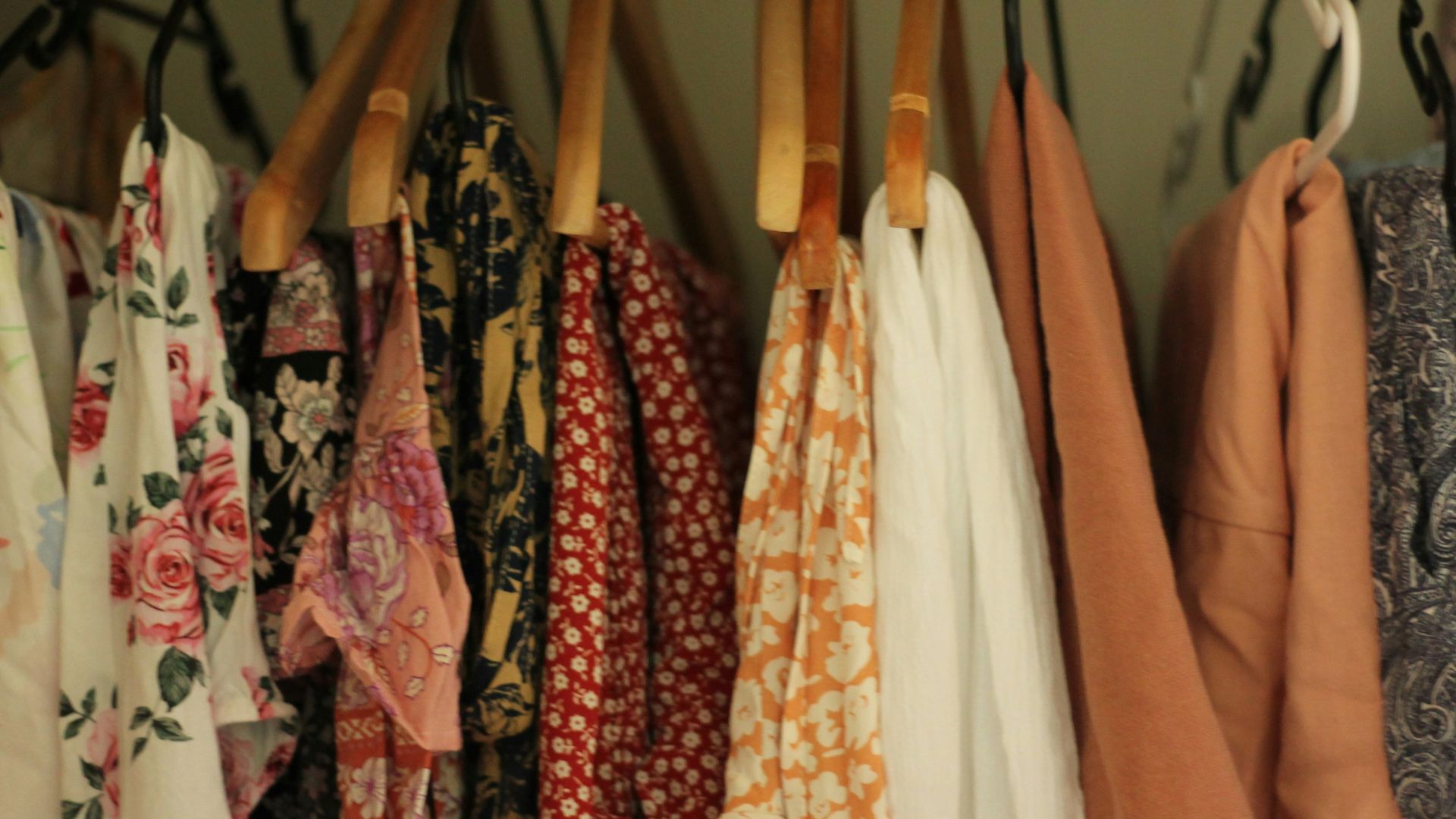 A rack of clothing hanging on a wall