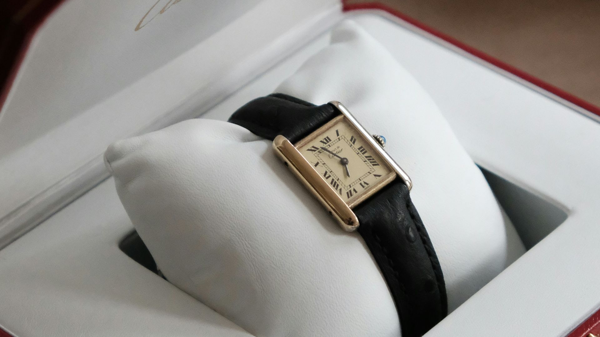 gold and black analog watch in box