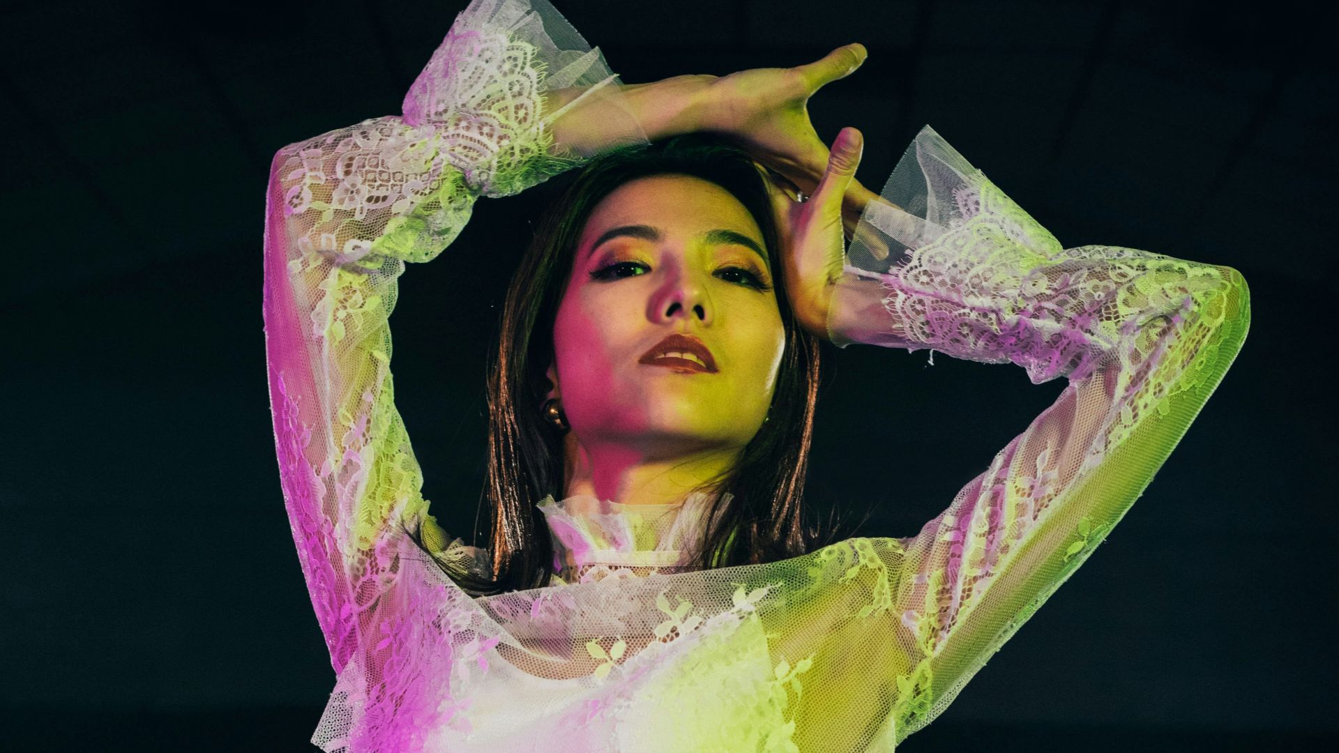 woman in yellow long sleeve crop top and pink shorts