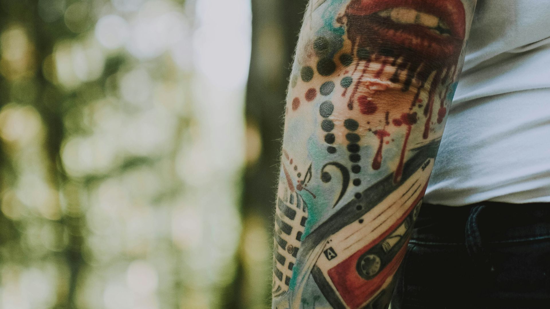 person with musical-themed tattoo on arm