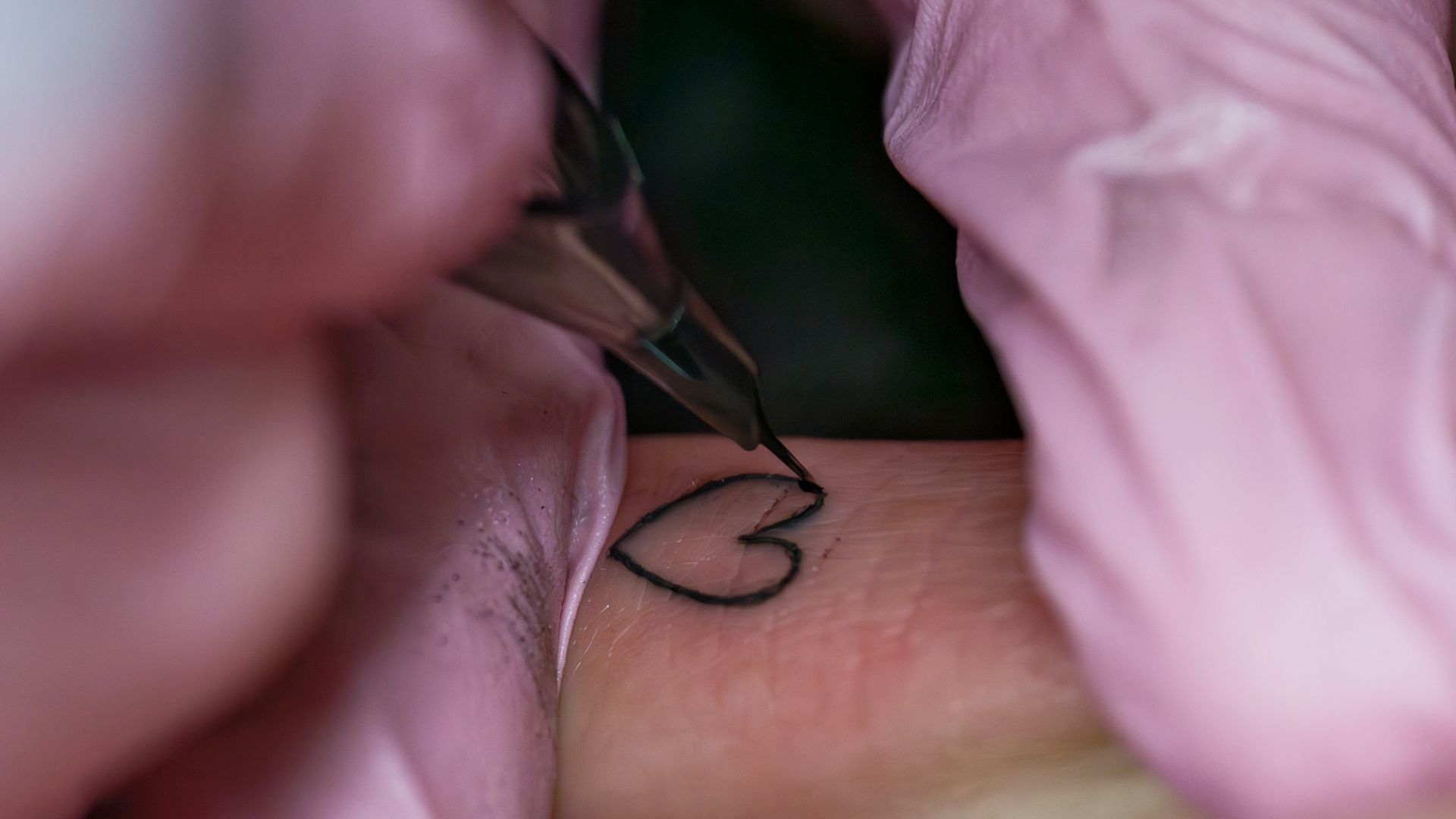 A woman getting a tattoo on her arm