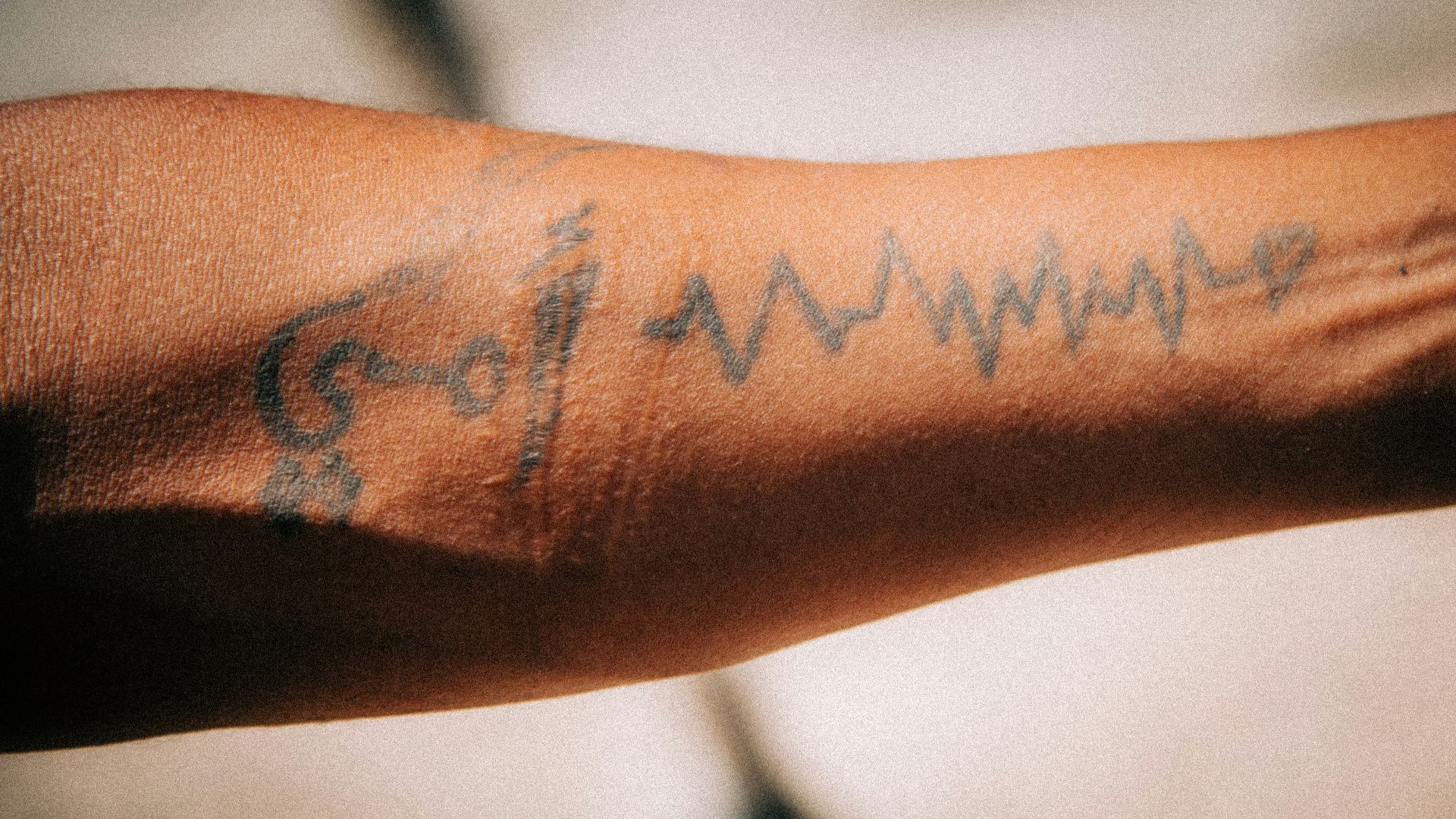 a close up of a person's arm with a tattoo on it