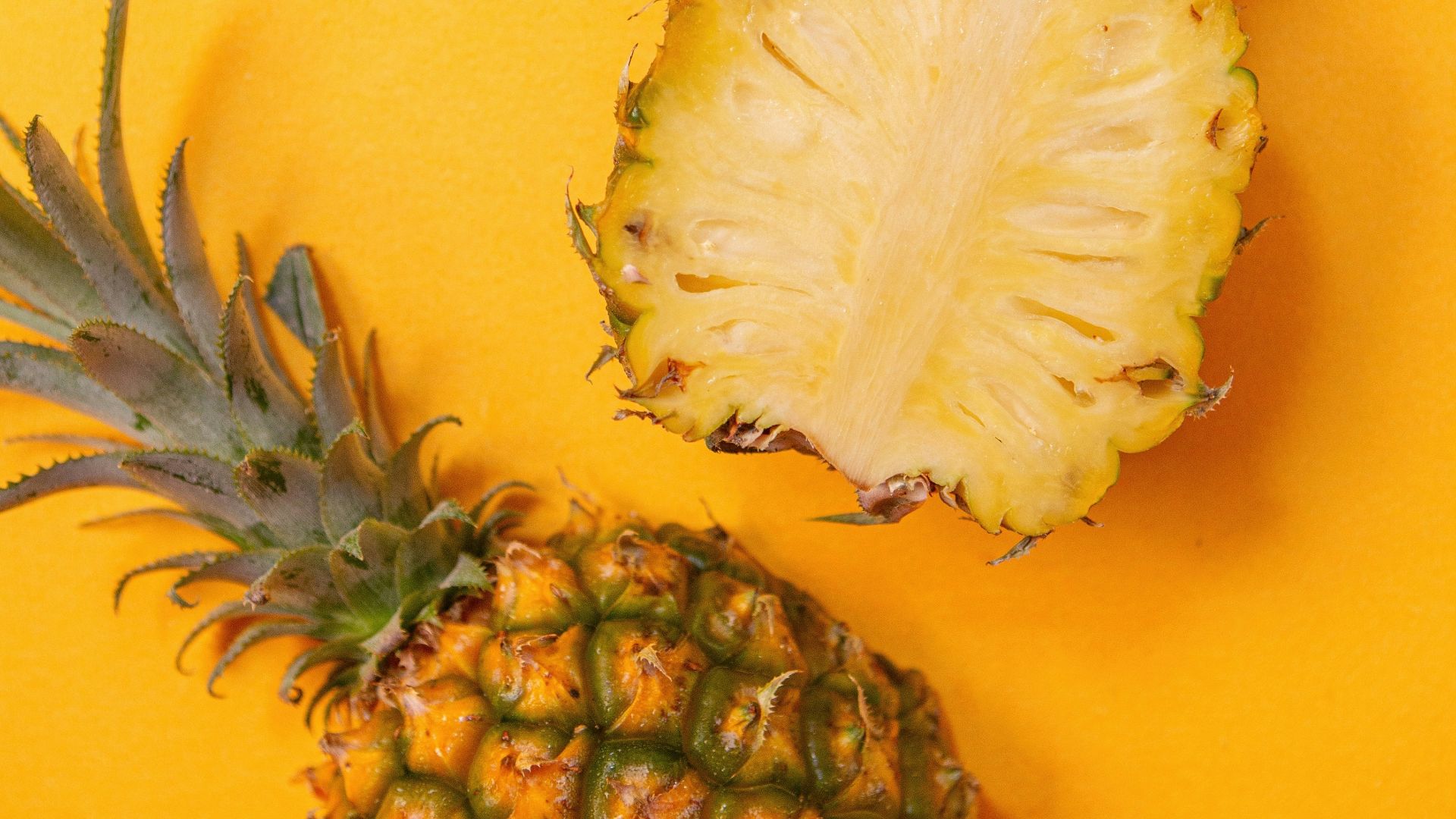 pineapple fruit on yellow surface