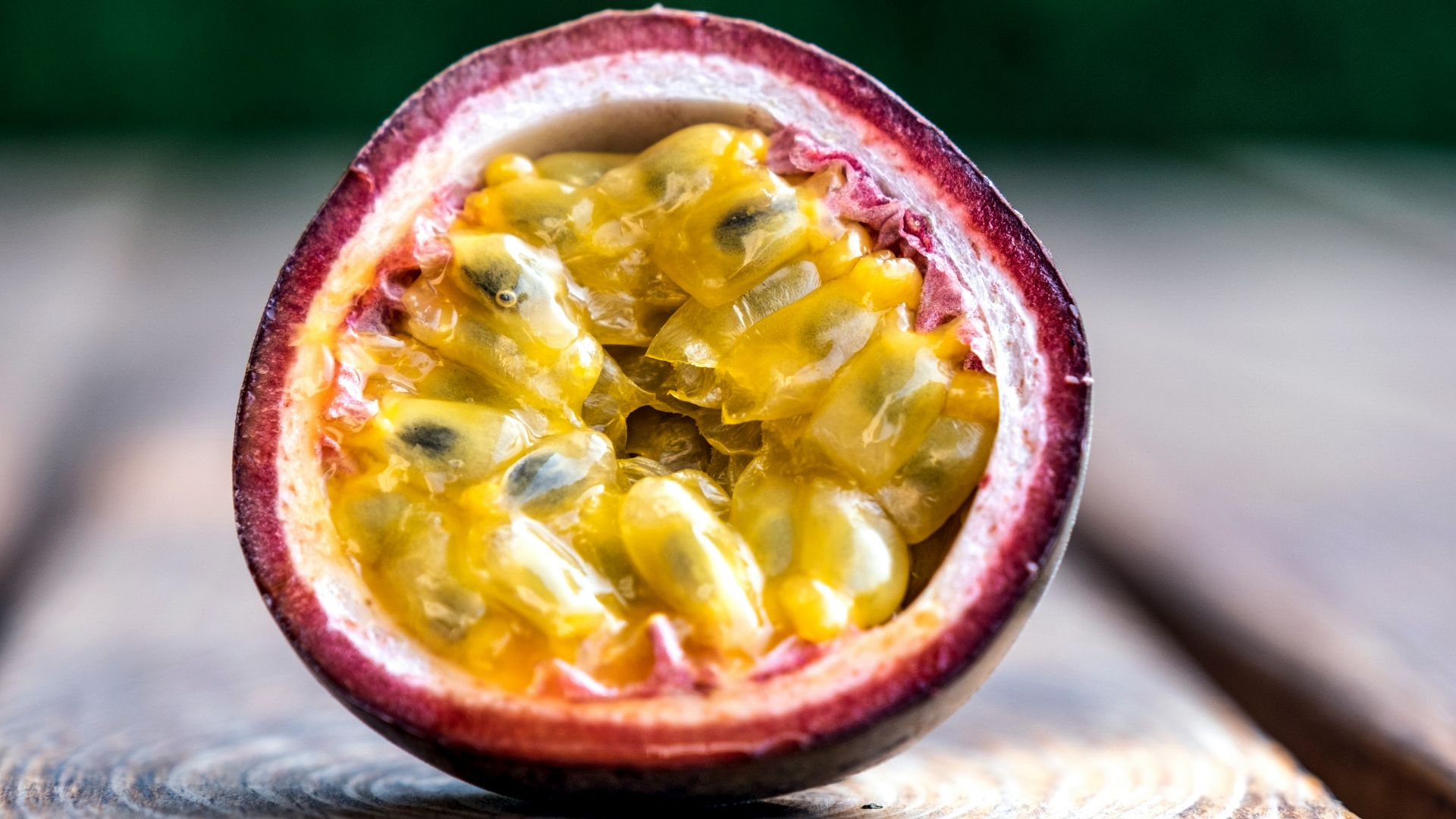 red and yellow round fruit on brown wooden table