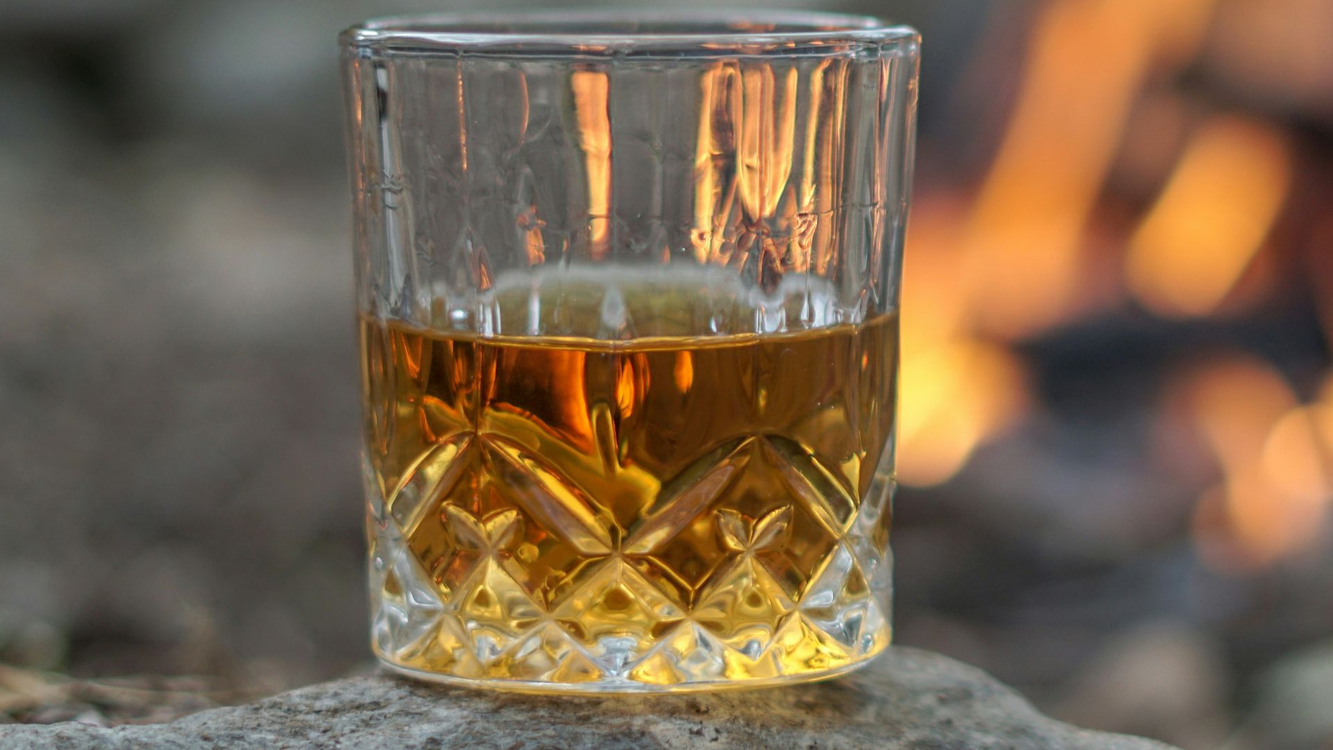 clear drinking glass with orange liquid