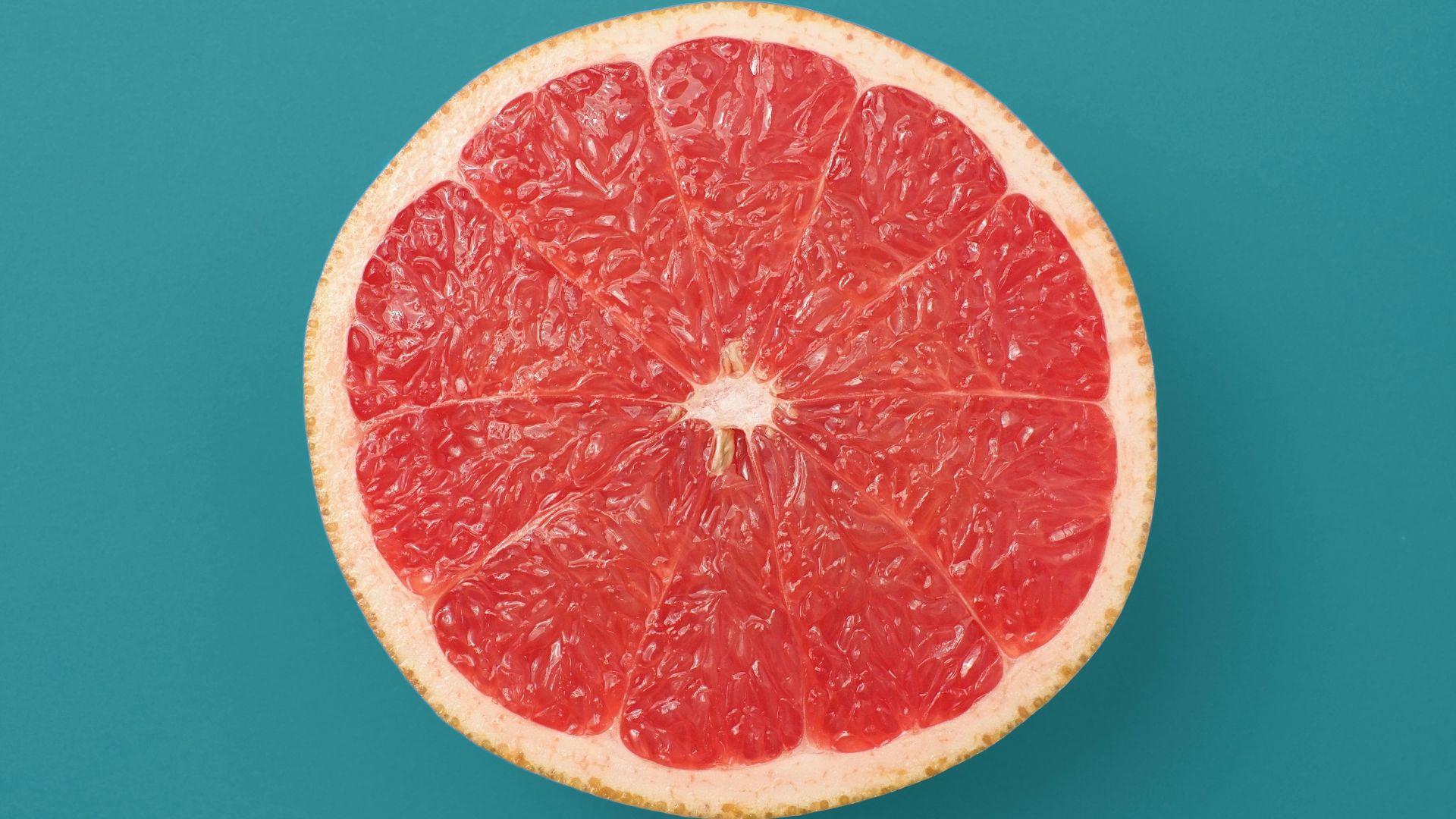 sliced orange fruit on blue background