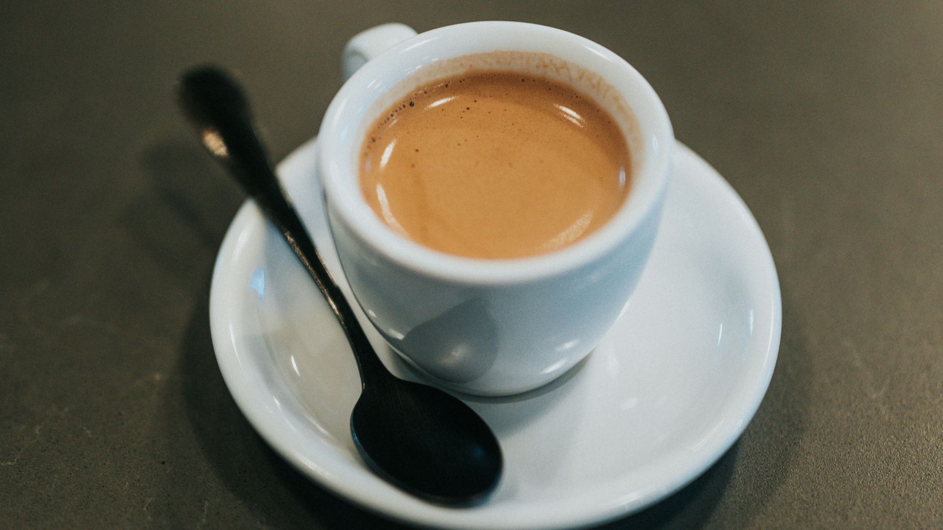 white ceramic cup with brown liquid