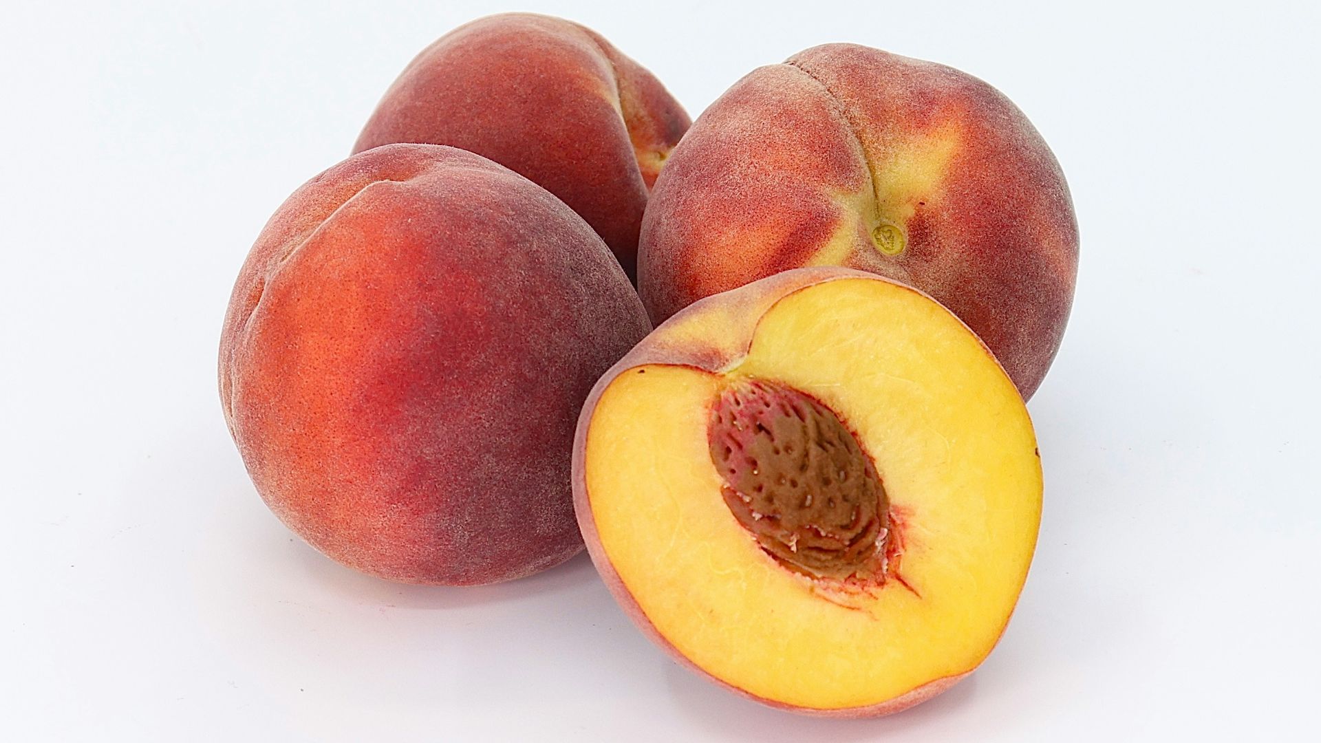 a couple of peaches sitting on top of each other