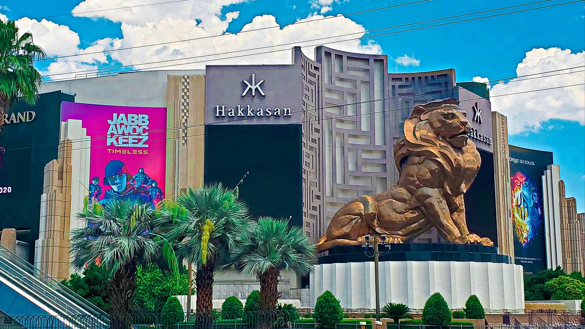 a large golden lion statue sitting in front of a building