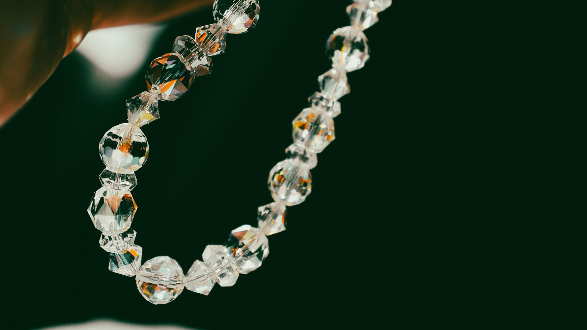A person holding a rosary in their hand
