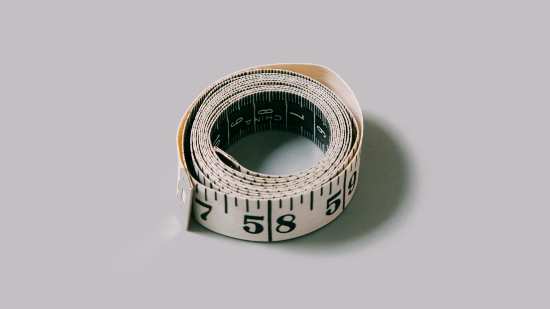 silver and gold ring on white surface