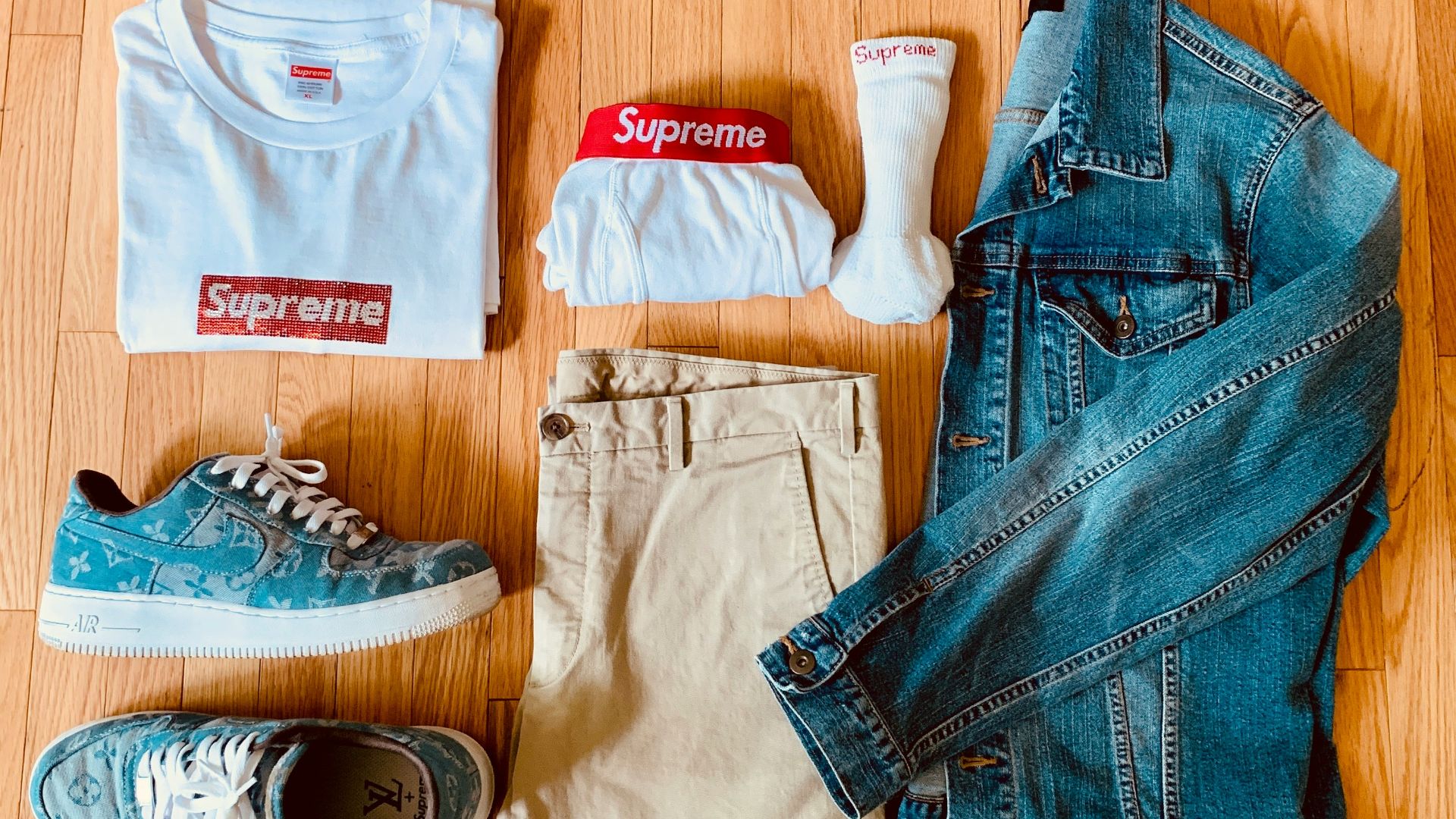 blue denim jeans and white and red crew neck shirt