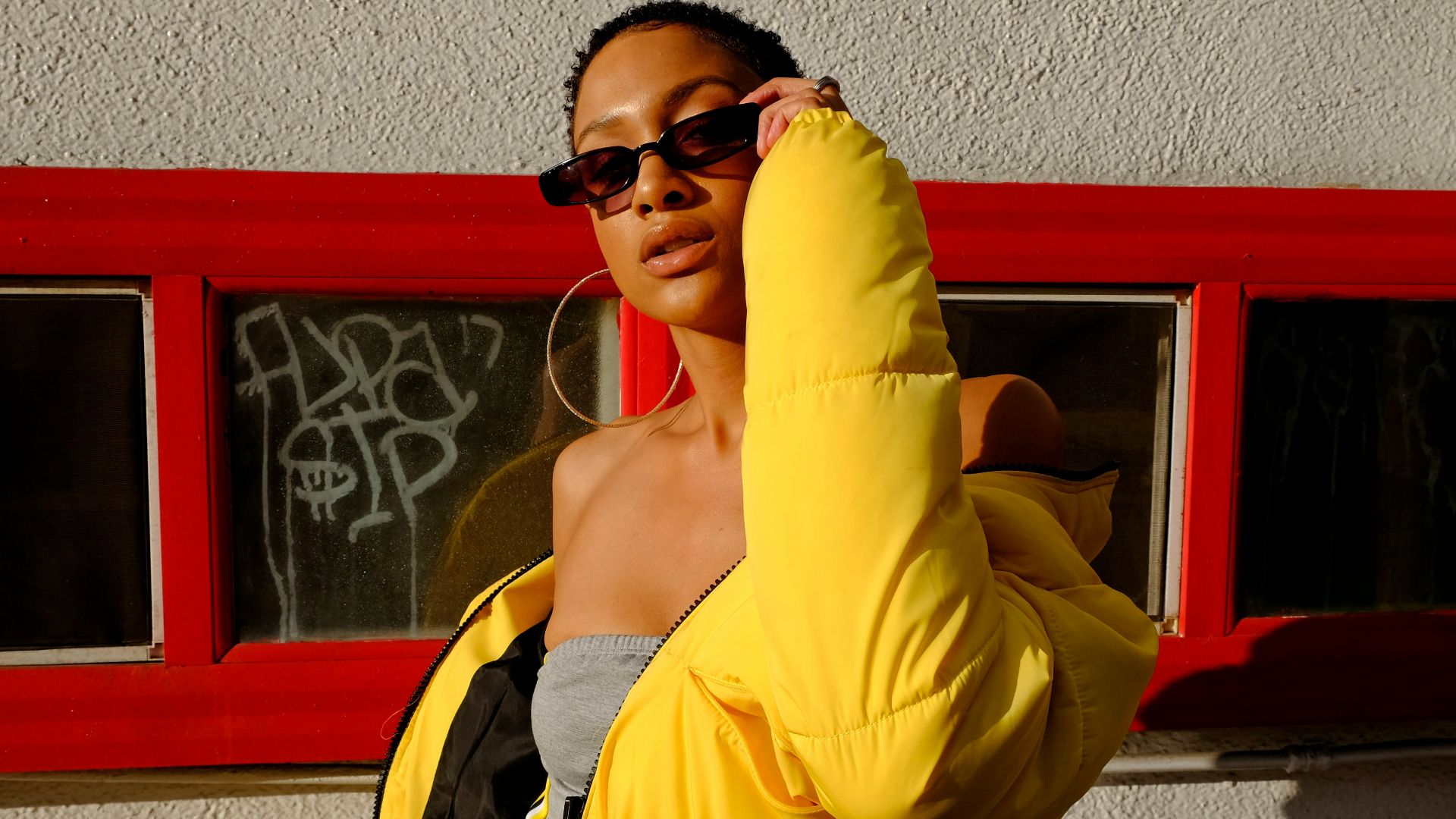 woman holding her sunglasses