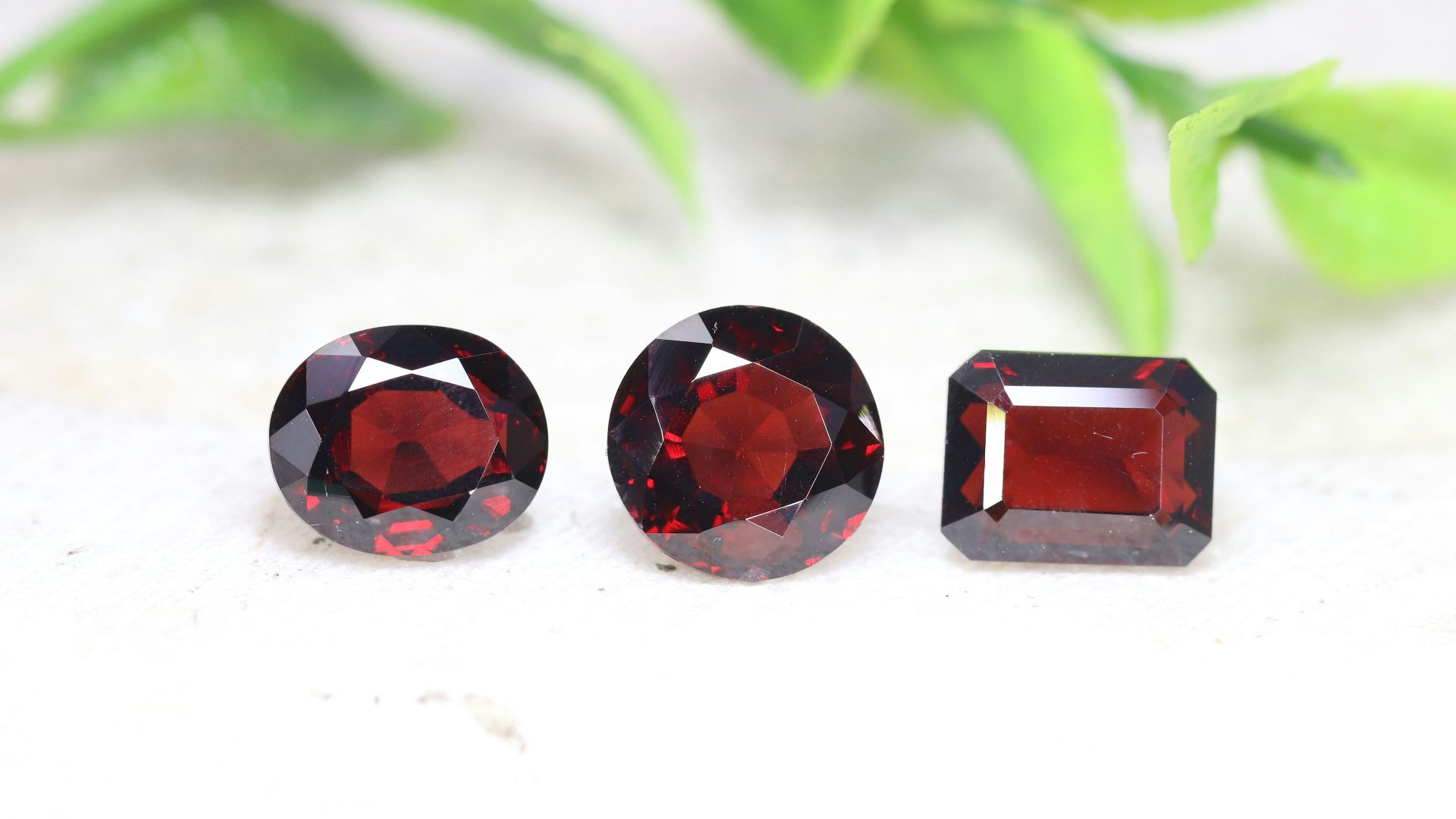 a group of three different colored stones on a white surface