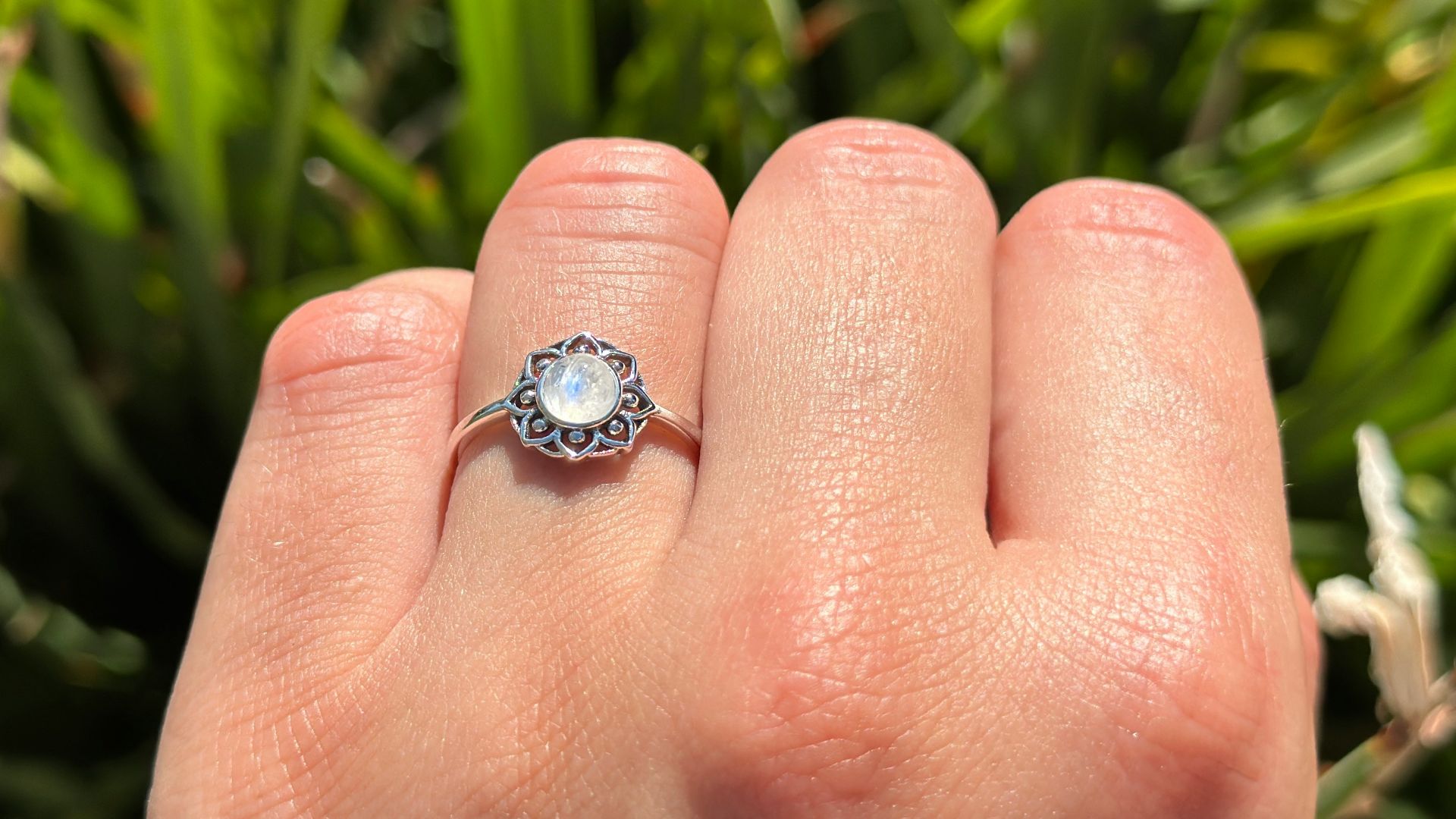 A hand displays a beautiful ring.