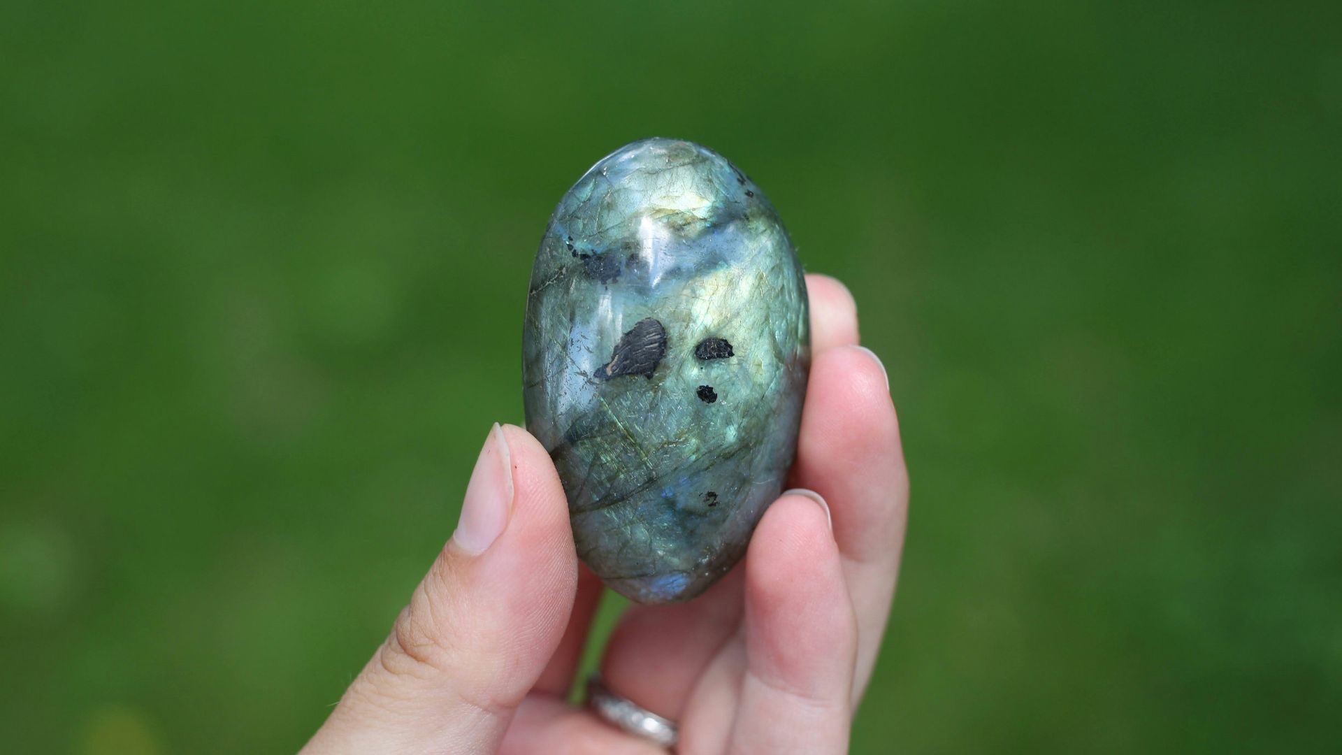a hand holding a blue rock