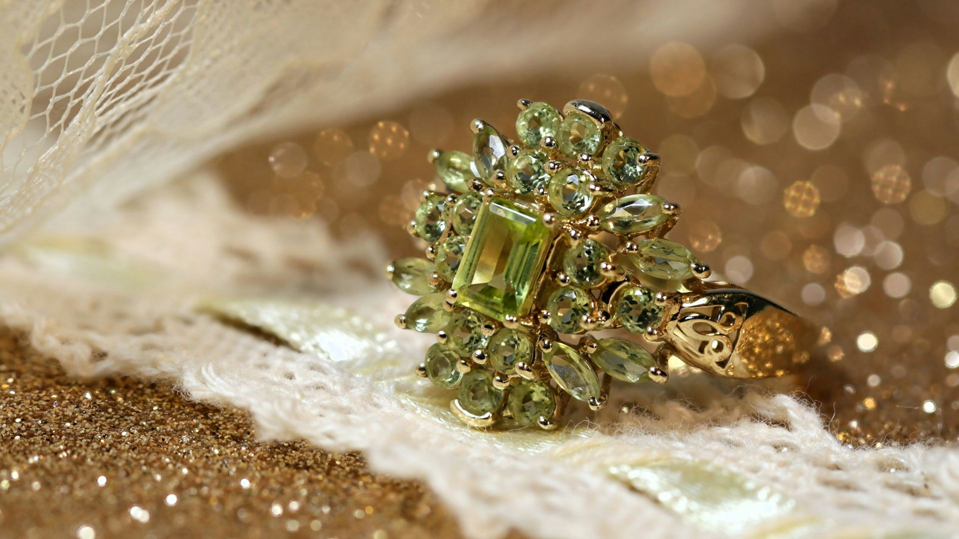 silver diamond studded ring on white textile