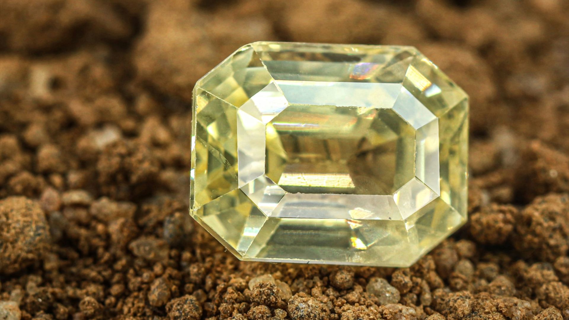 a yellow diamond sitting on top of a pile of dirt
