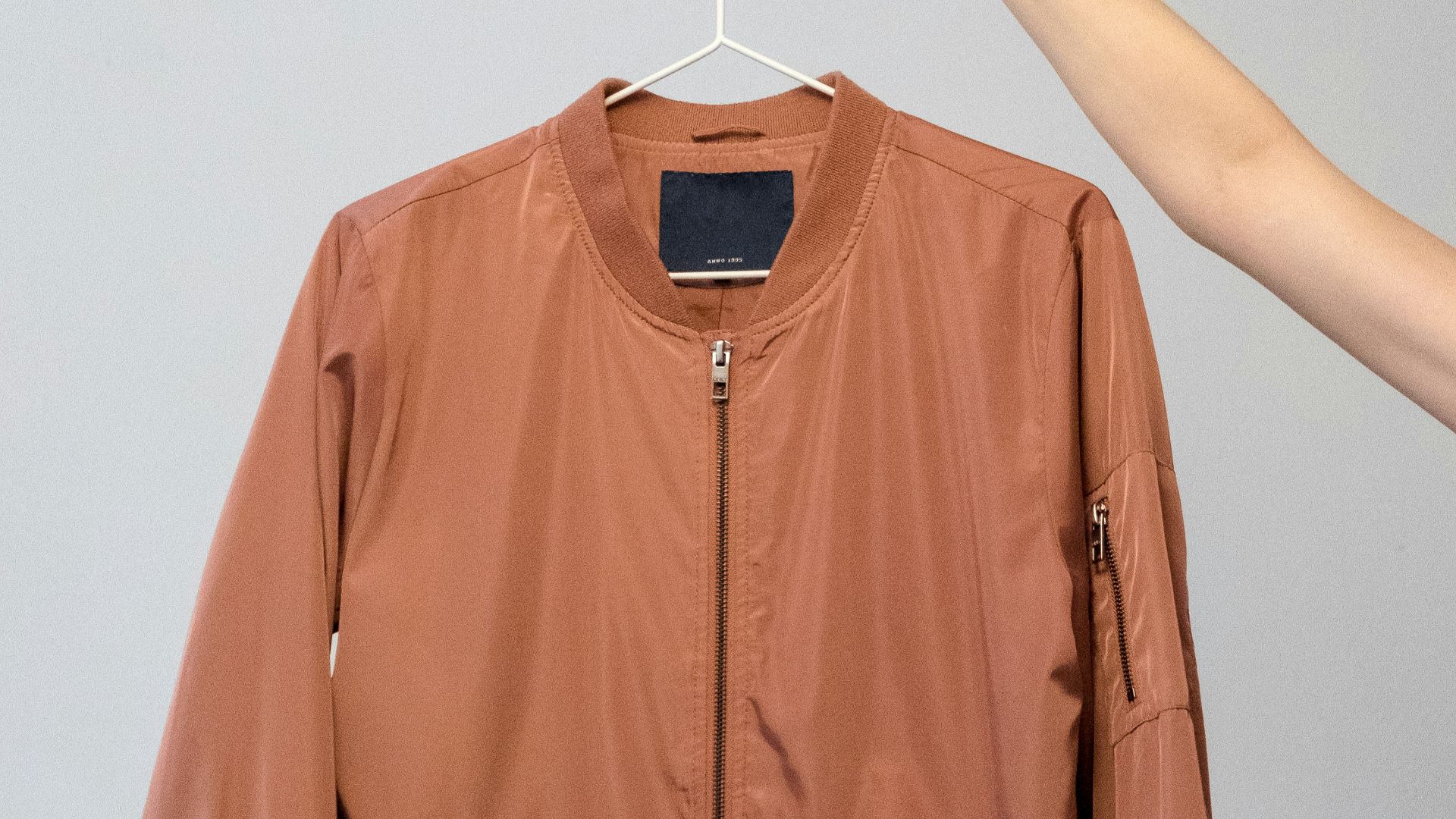 brown long sleeve shirt on white clothes hanger