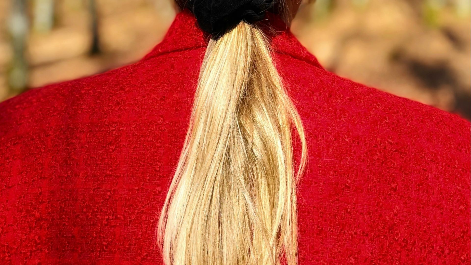 woman in red shirt with blonde hair