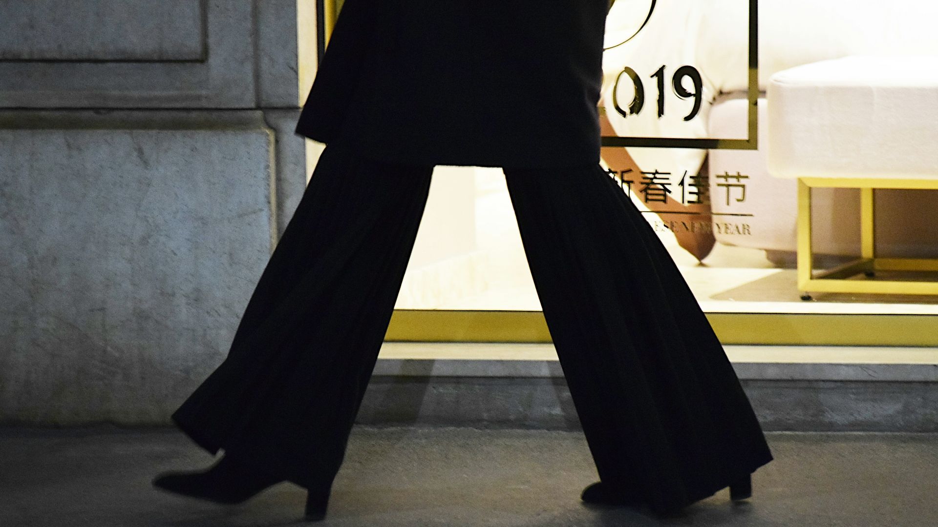 person wearing pair of black chunky heels