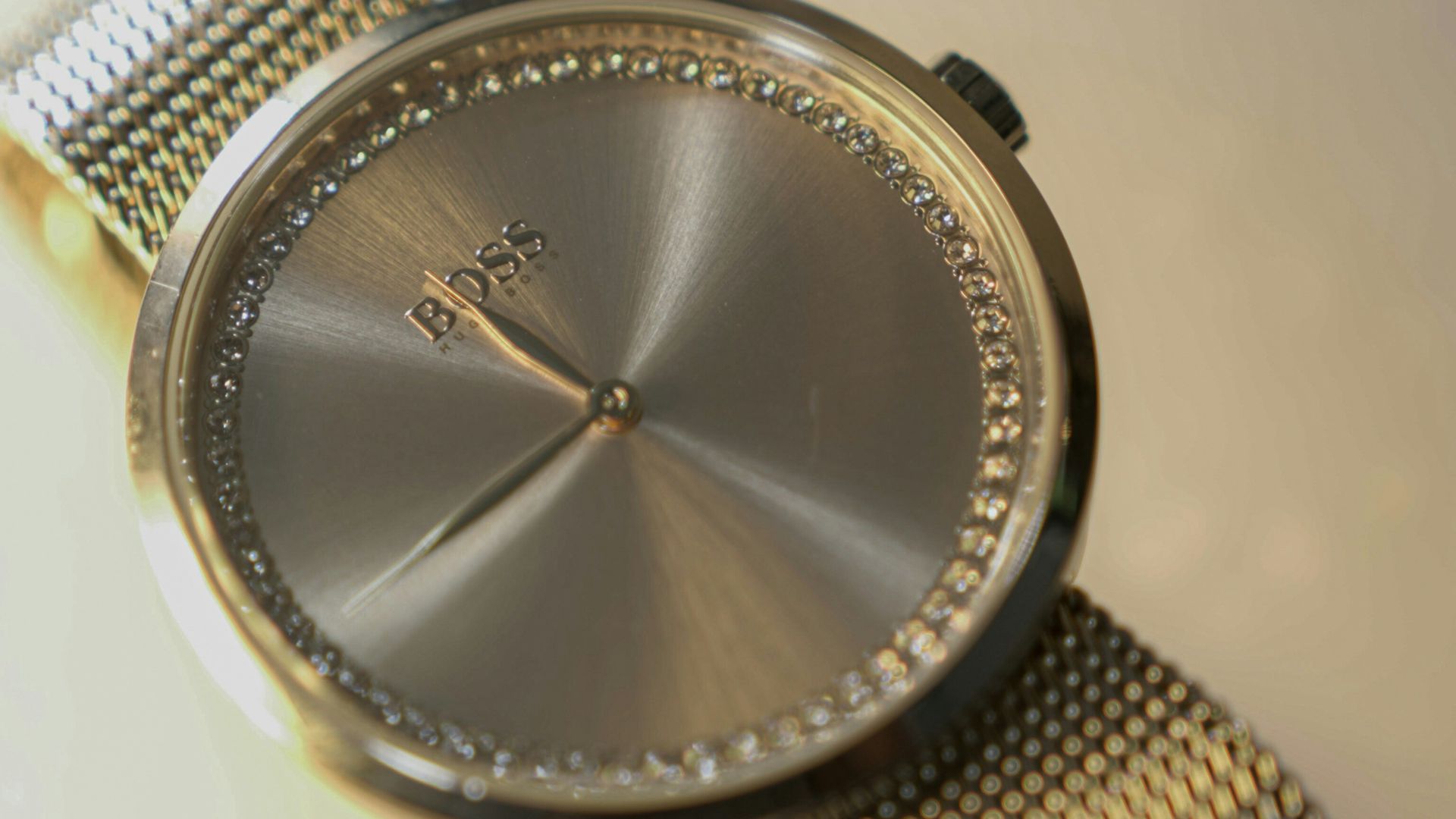 A silver watch with a mesh band