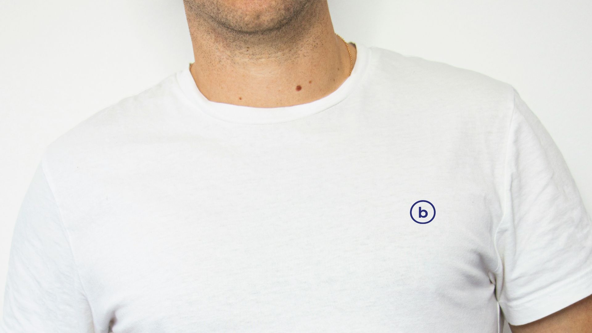 man wearing white crew-neck shirt and black denim jeans with hands in pocket